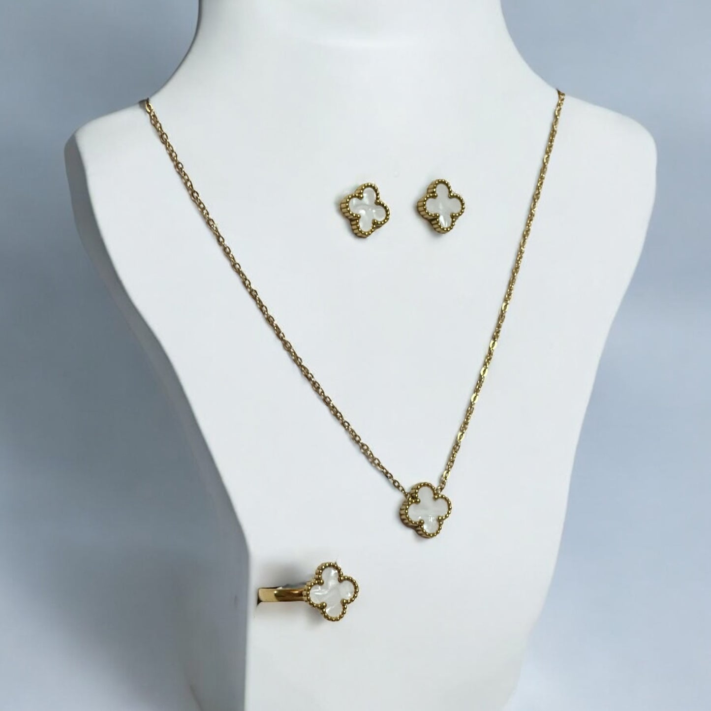 Elegant clover neck chain set featuring a delicate pendant, matching earrings, and a stylish finger ring in gold finish.