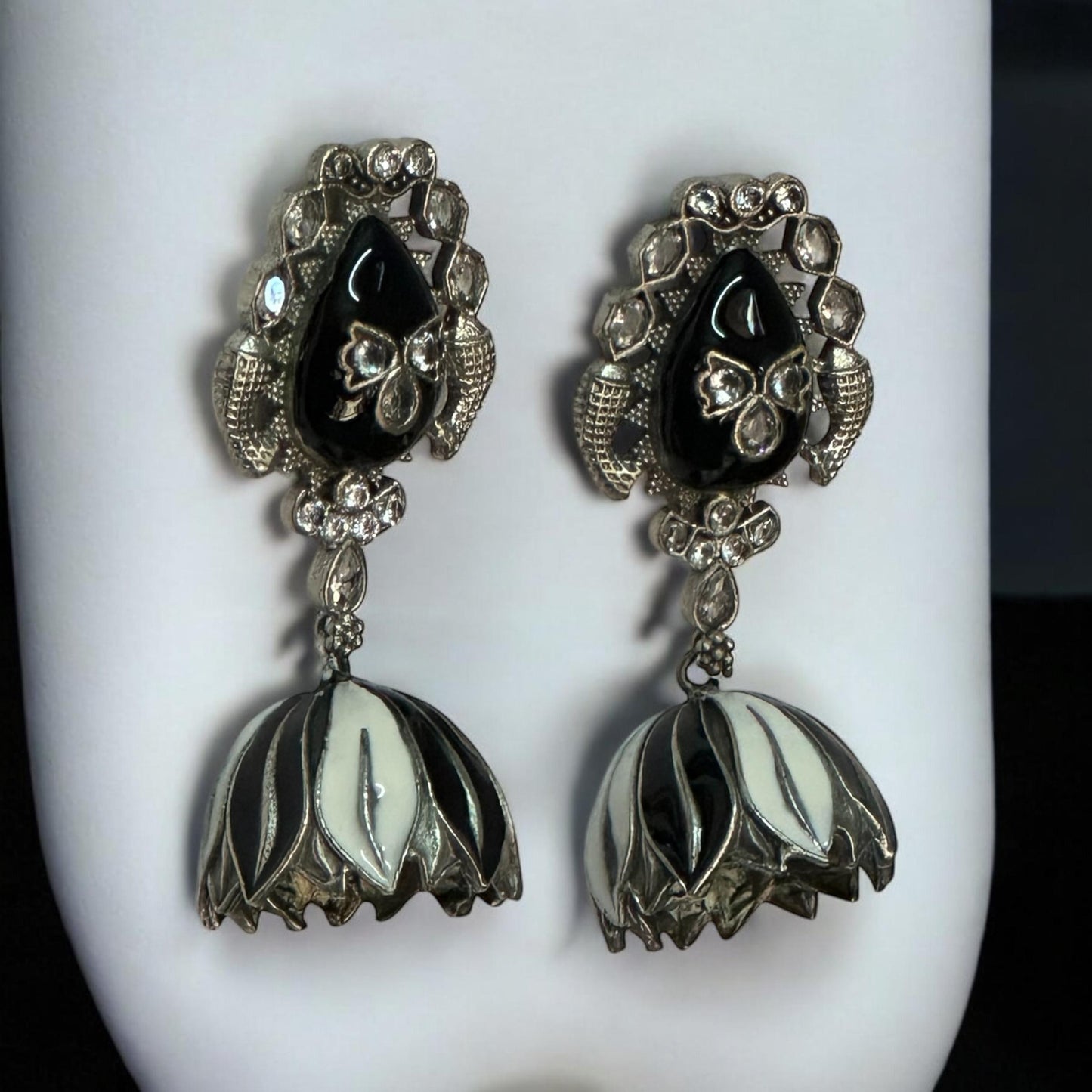 side view of Silver replica jhumki earrings with black and white enamel dome and crystal detailing – Indian designer jewellery by Bella & Diva.
