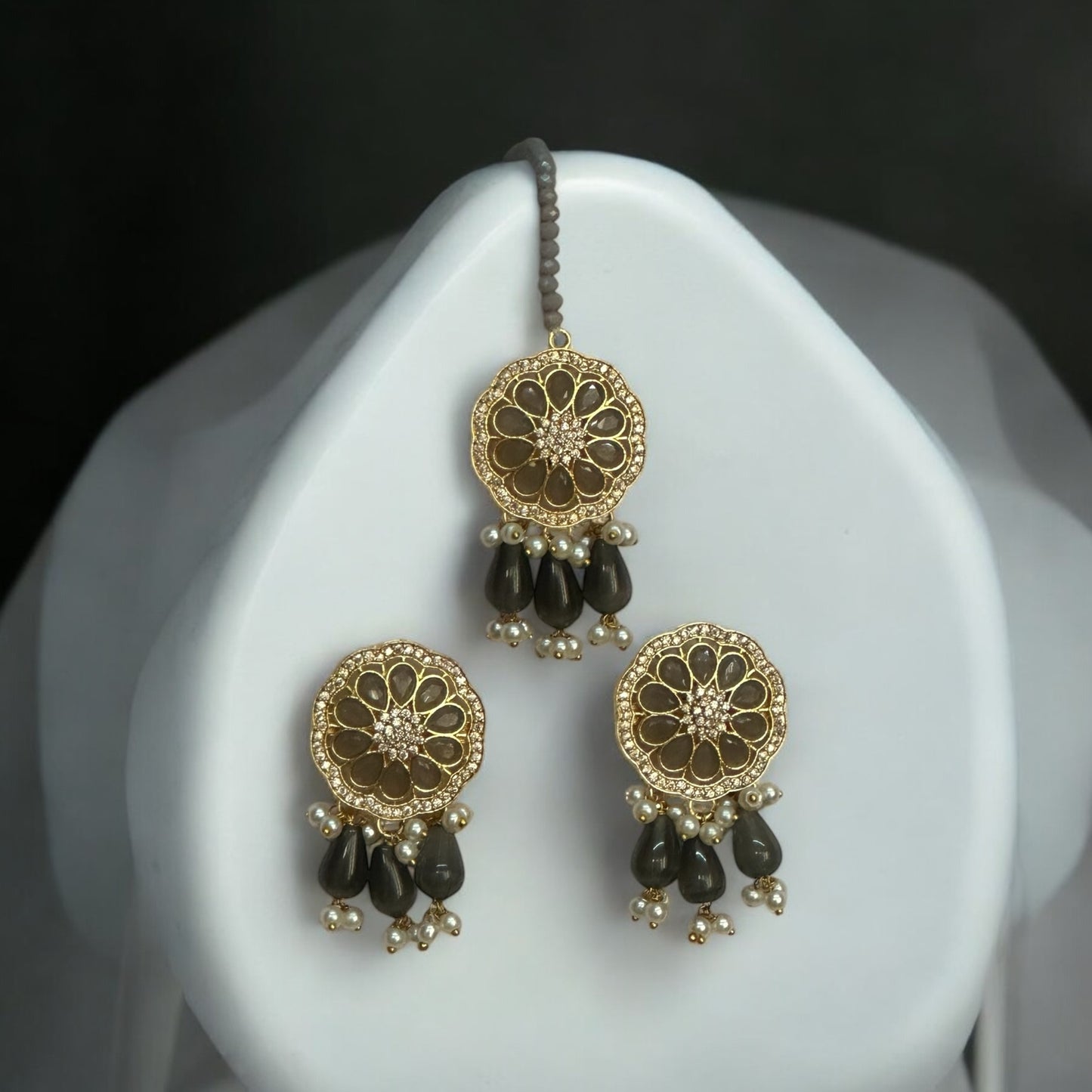 Kundan Pearl Grey Earrings and Tikka – multi-layered grey beaded earrings and tikka featuring gold-toned kundan work, pearl accents. Perfect for festive and wedding occasions.