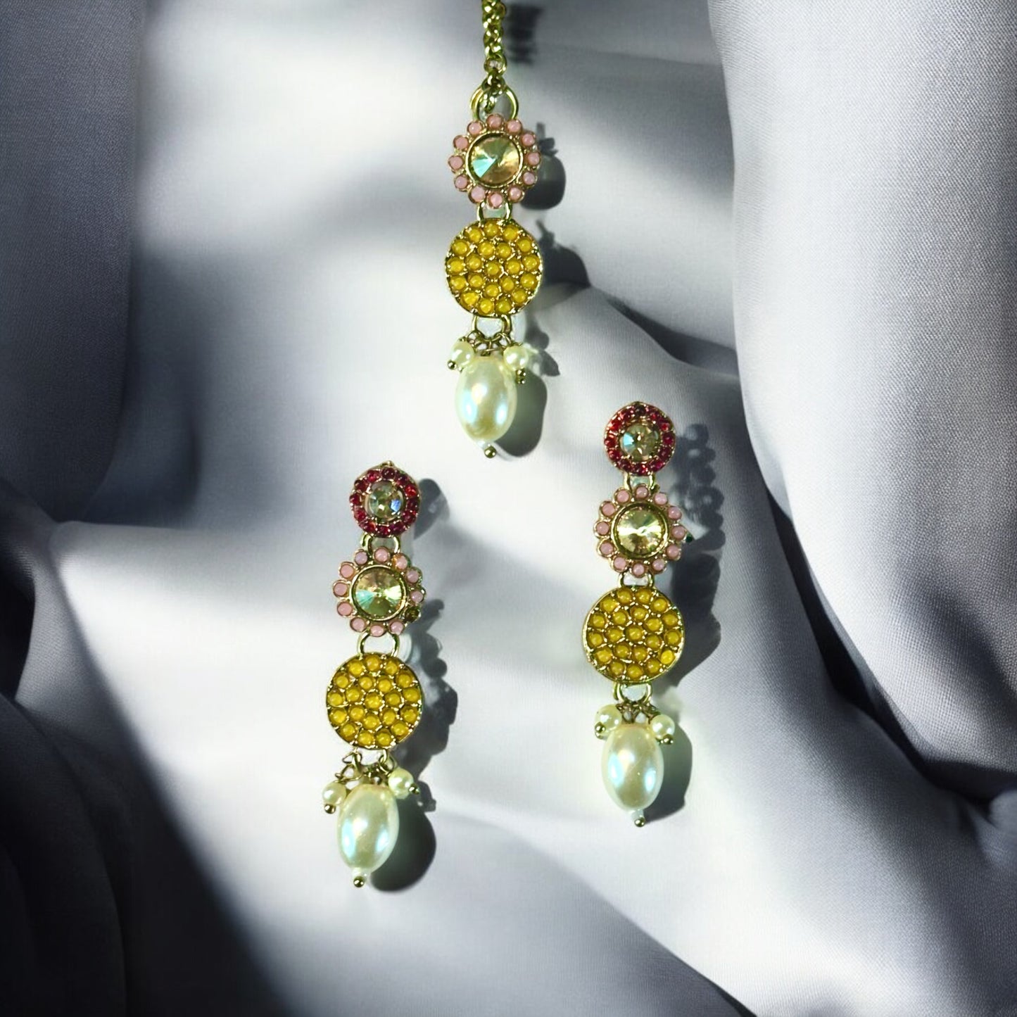 Pakistani Kundan Choker Earrings With Tika decorated on a white colored fabric.