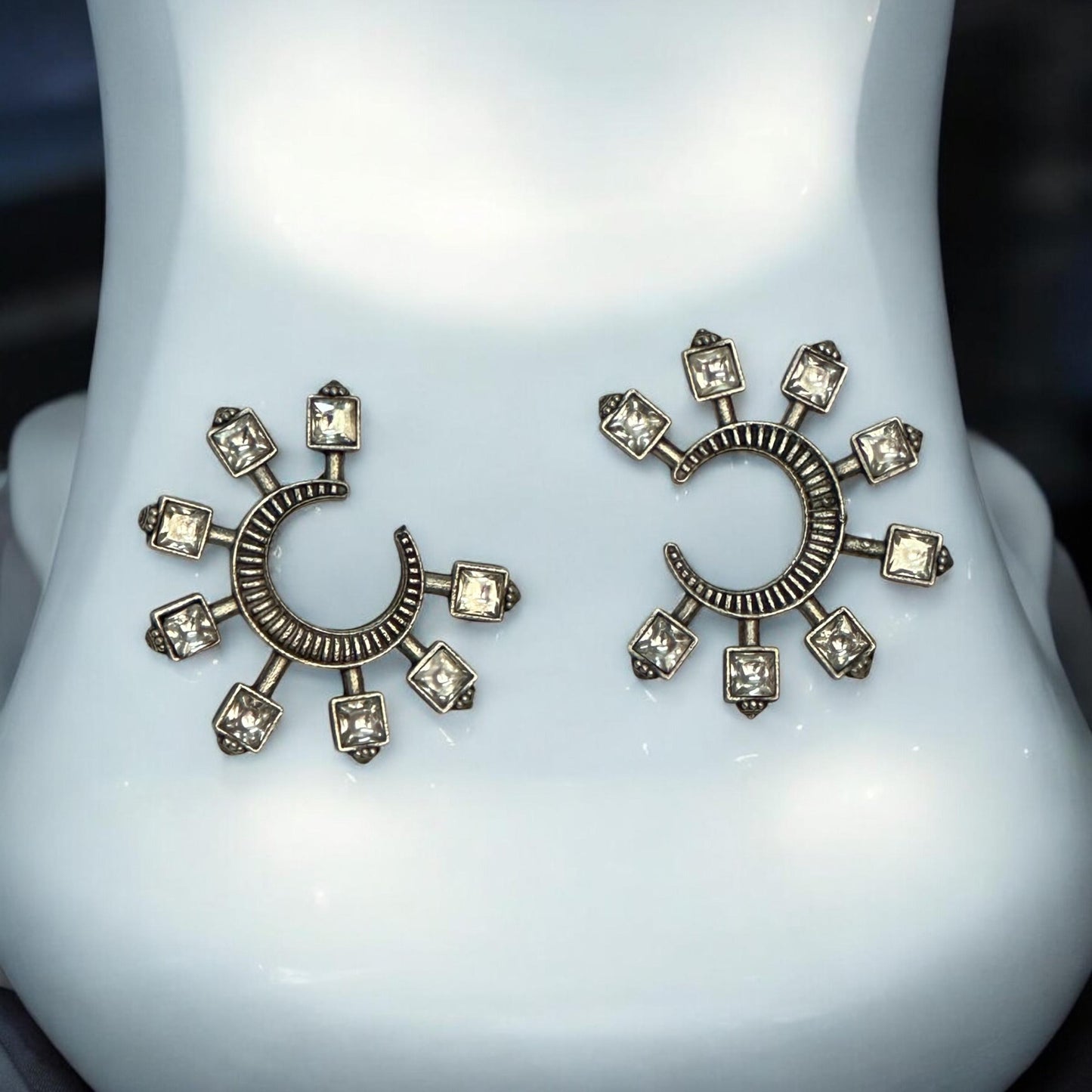 Polki silver look-alike crescent and square-cut stone earrings displayed on a white jewellery stand – Bella & Diva