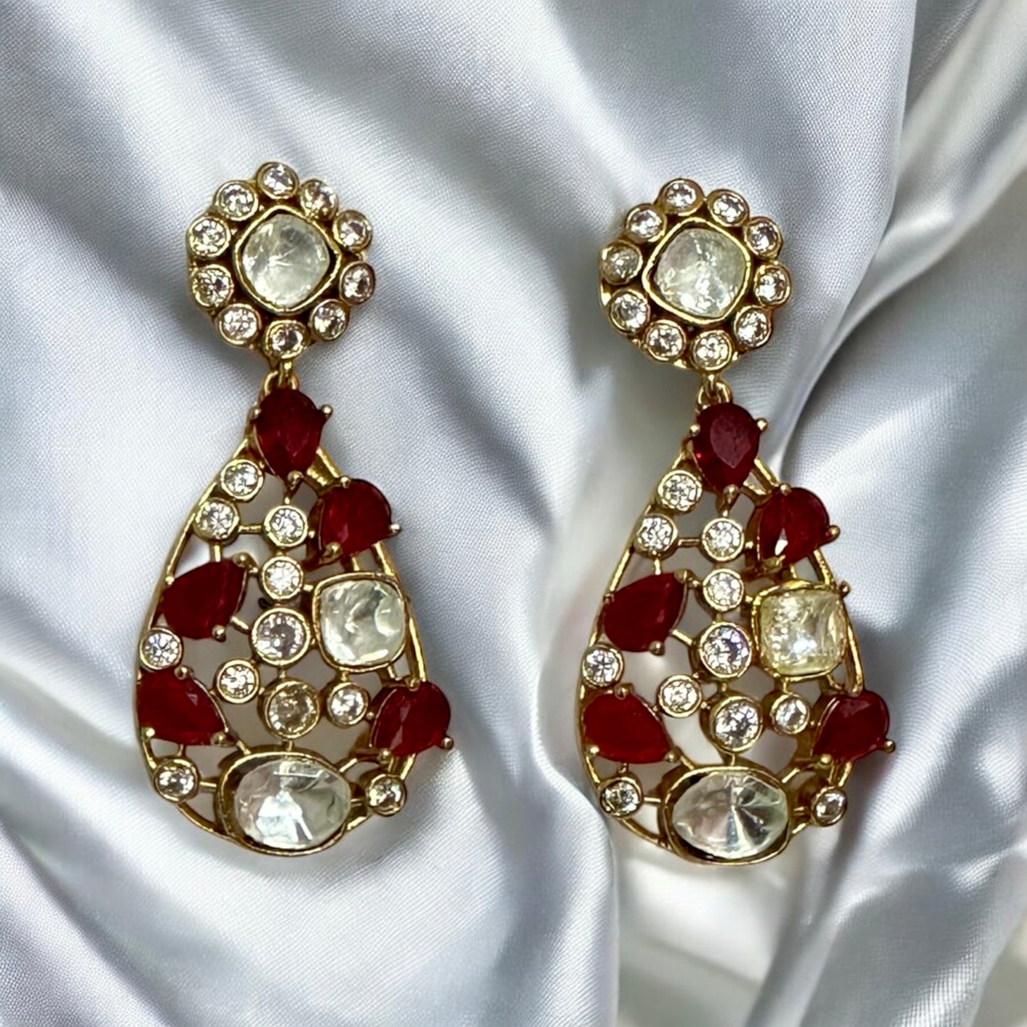 Premium Polki Kundan necklace set's Earrings with red diamond accents on white silk background β Bella & Diva