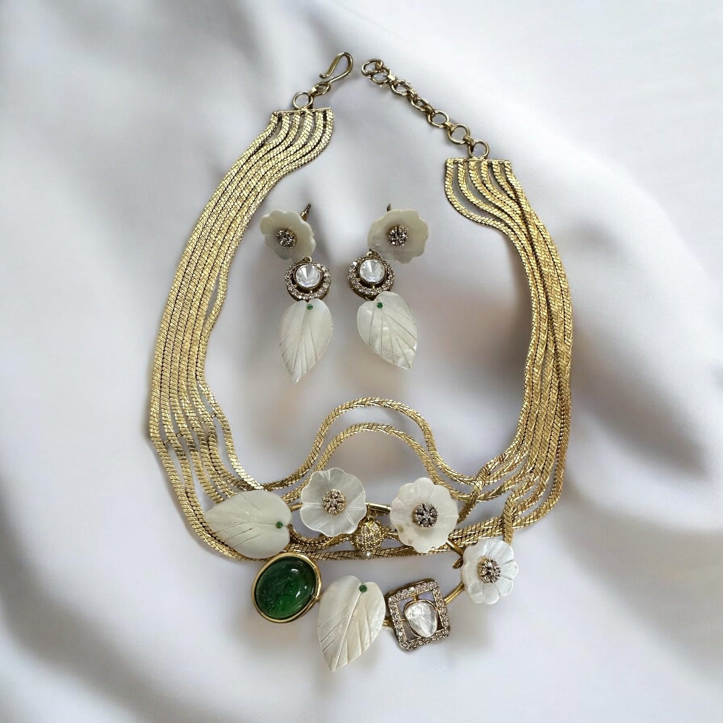 Real MOP_Mother Of Pearls_Moissanite Gold Plated Kundan Chokar With Earrings lying on a white fabric background.