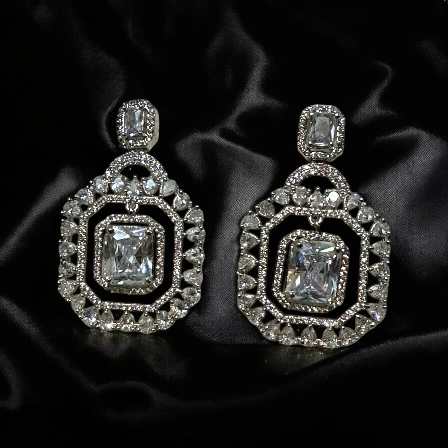 A pair of an American Diamonds Statement Earring on a shiny black coloured fabric background