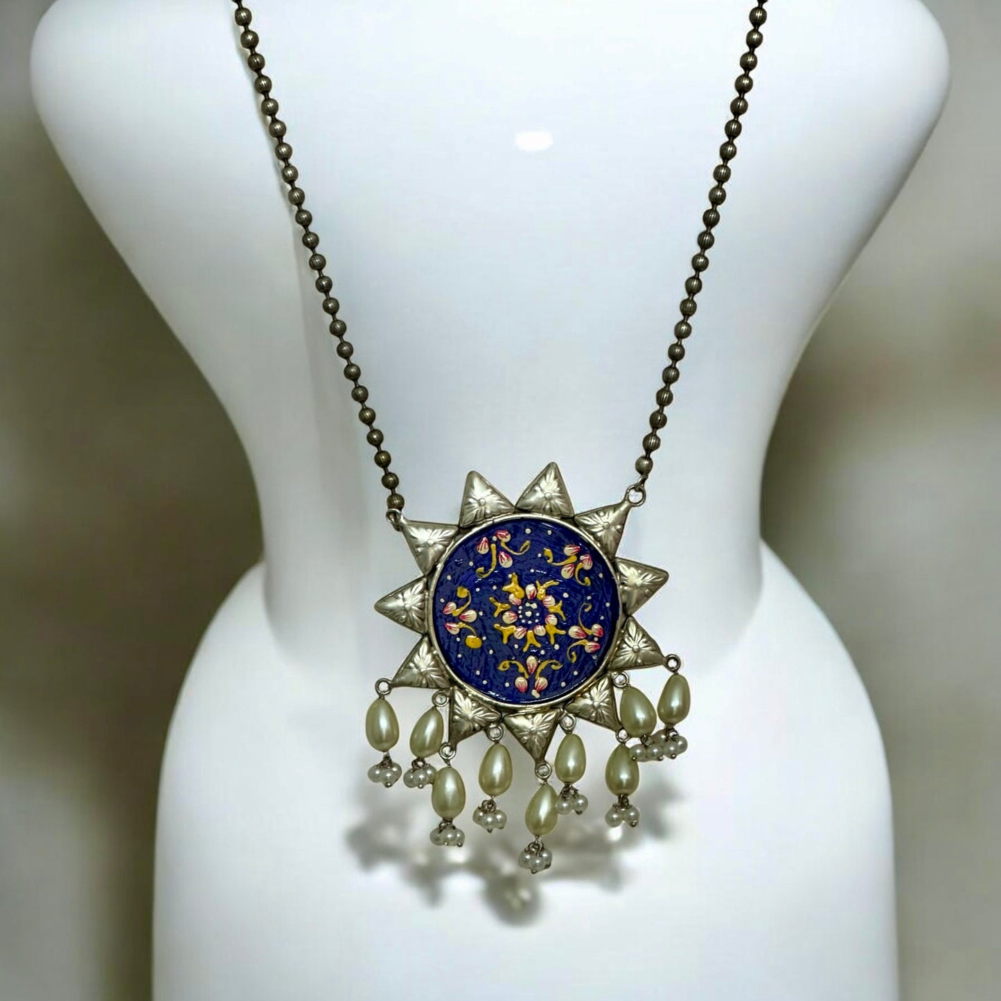 Oxidized silver replica necklace with large blue floral pendant on mannequin β Bella & Diva
