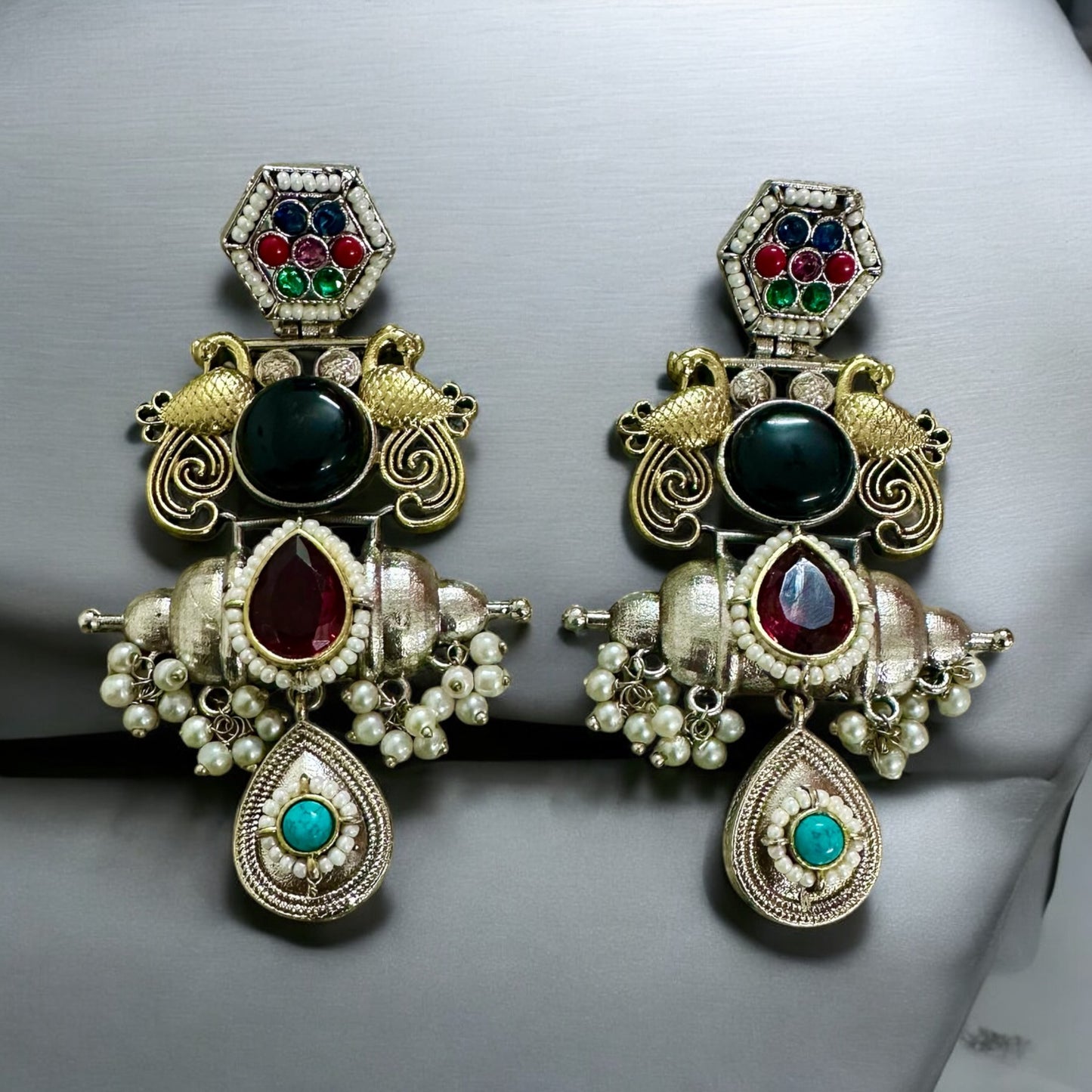 Statement Jadau Kundan Handmade earrings in Dual tone standing on a grey background