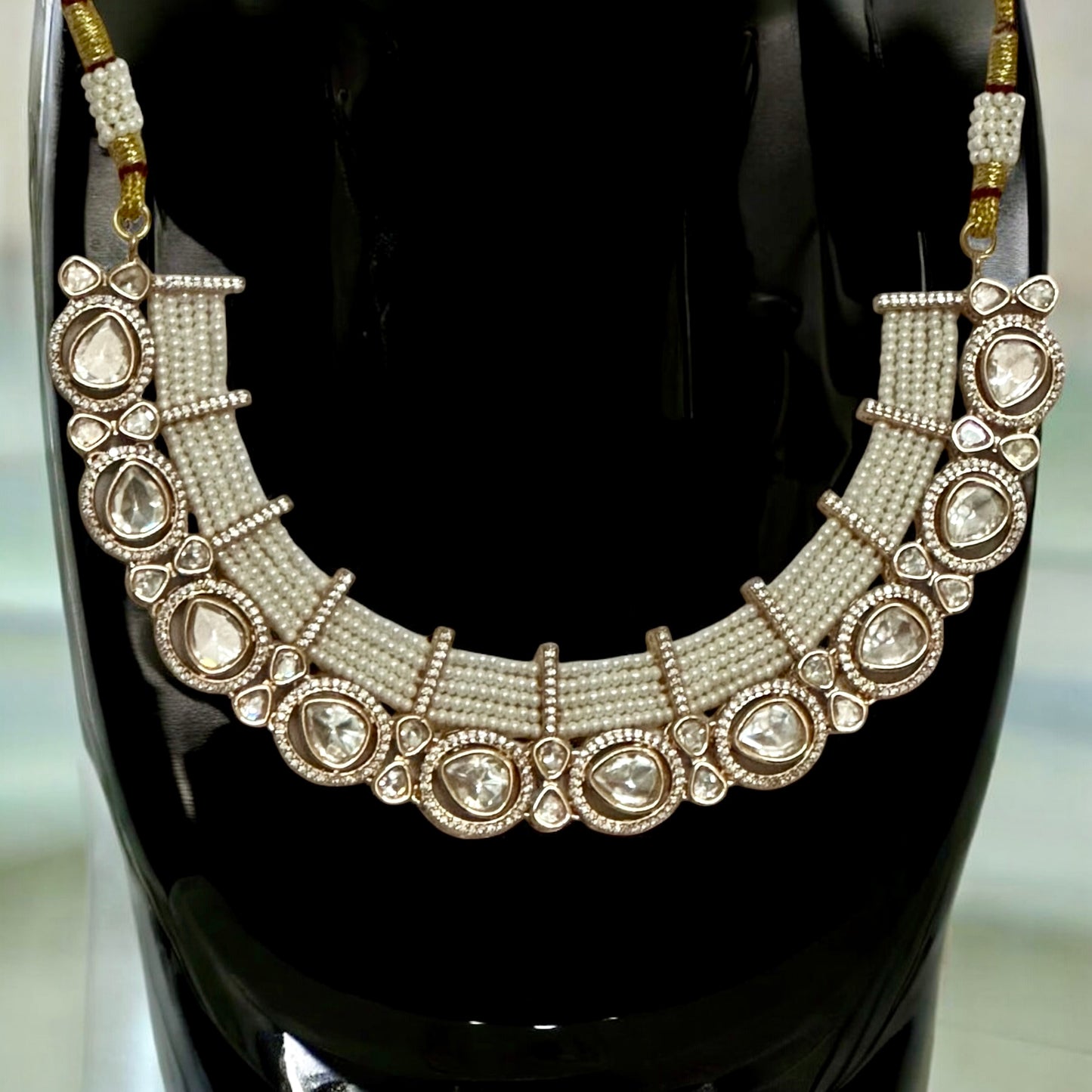 Tyani Kundan pearl necklace displayed on a black coloured jewellery display stand β Bella & Diva