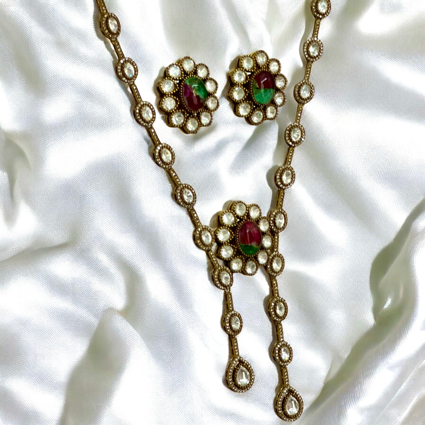 Side view of Premium Indian moissanite necklace with double marble stone & studs on white silk background β Bella & Diva