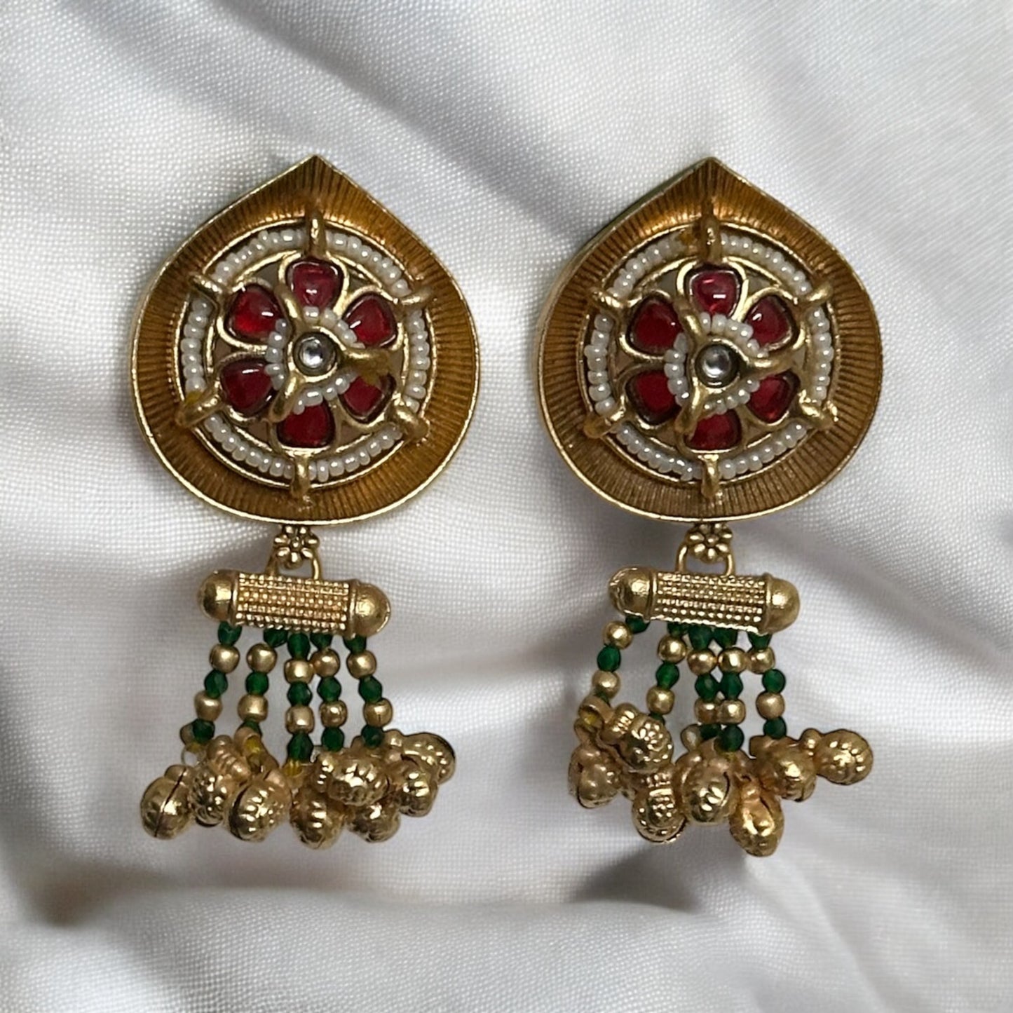 Rajwadi Kundan earrings hanging on a black colored fabric.