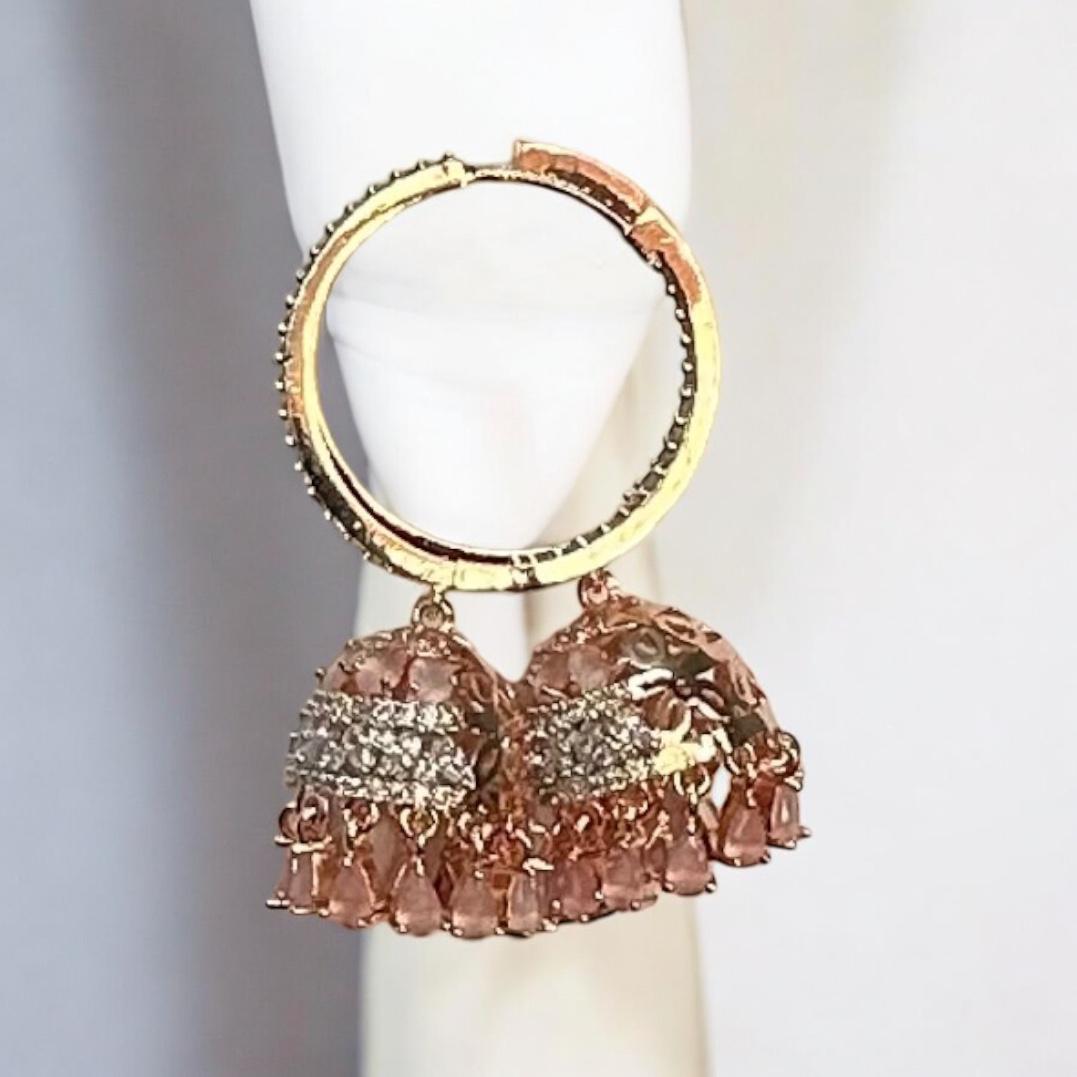 American Diamond peach colour big jhumka earrings with crystal detailing and rose gold finish – designer Indian jewellery for weddings and parties displayed on a white background.