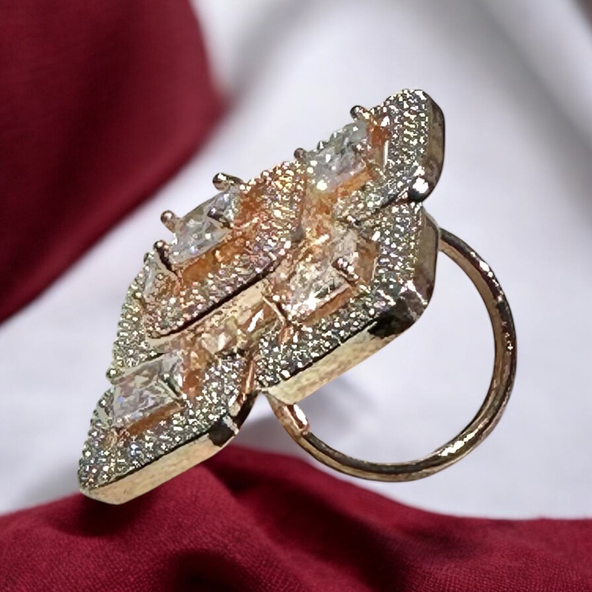 side view of an American Diamond Finger Ring in 5 squares design with a diamond in each square on a red and white background 