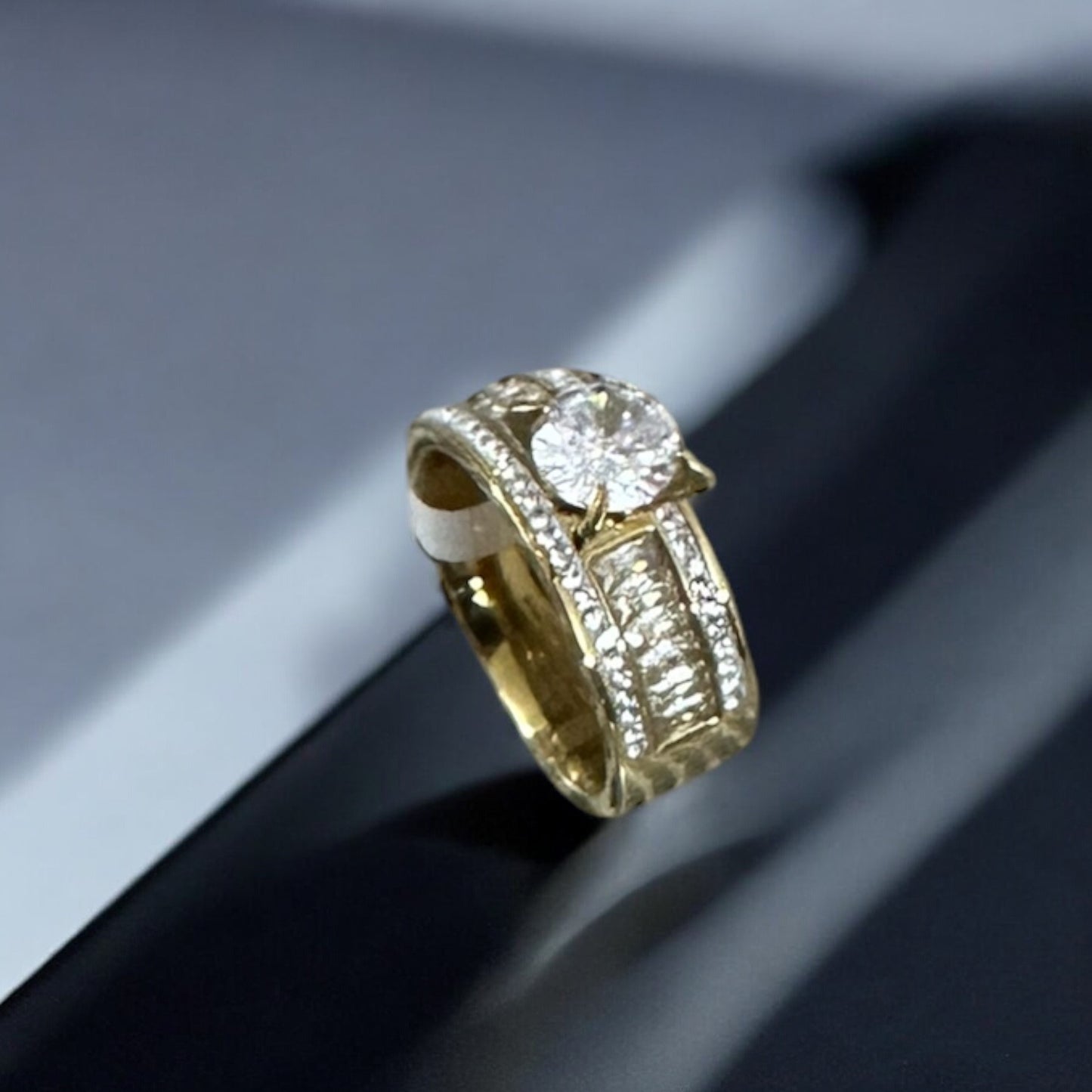 top side view of an American Diamond Finger Ring with a big diamond piece in the centre on a black and white blur background 
