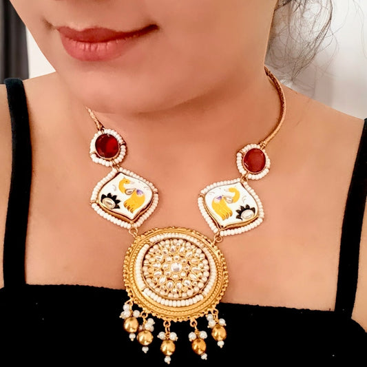 A model displaying an Amrapali Designer Hand-Painted Red Necklace with Studs – a traditional masterpiece with pearl detailing, Kundan stones, and intricate hand-painted motifs.