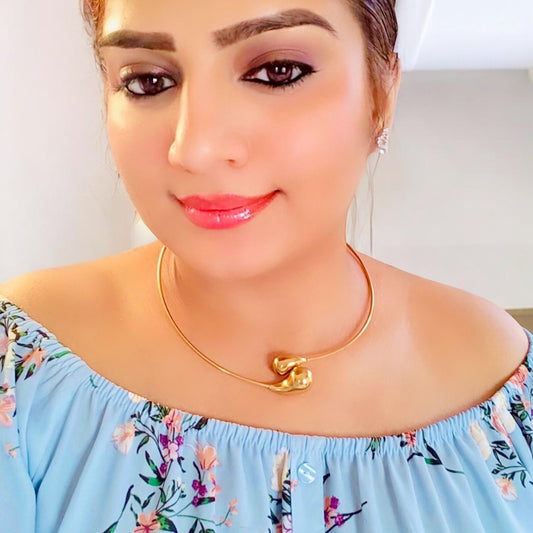 A Model Displaying Anti-Tarnish Hasli Design Partywear Gold-Toned Necklace with Minimalistic Style.