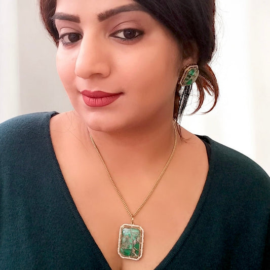 A Model Displaying Beautiful Doublet Green Diamond Chain Pendant Set with Earrings – gold-tone pendant set featuring a rectangular green doublet stone framed with shimmering diamonds. Perfect for formal and festive occasions.