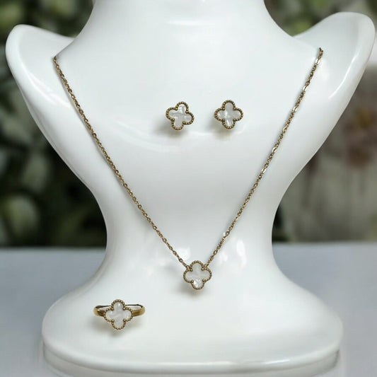 Elegant clover neck chain set featuring a delicate pendant, matching earrings, and a stylish finger ring in gold finish. It is displayed on a white coloured jewellery display stand.