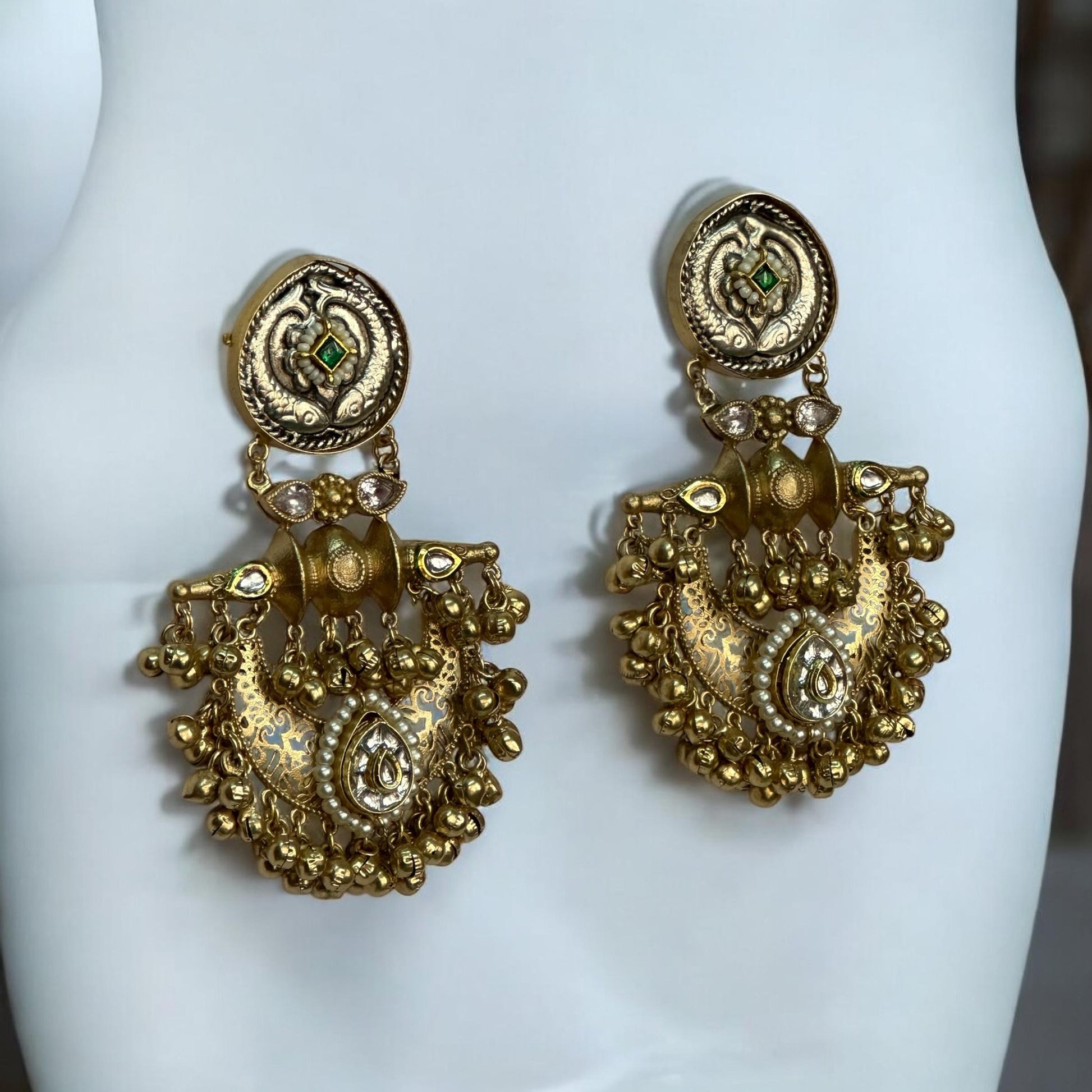 Traditional gold-toned Pachi Kundan earrings with intricate detailing and Apala polish – designer Indian statement earrings placed on a white jewellery display stand.