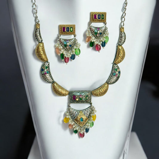 Dual tone silver look alike necklace and earrings with multicolour beads placed on a white coloured jewellery display stand.