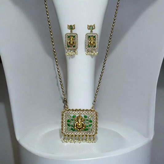 Dual-tone silver replica long chain pendant set featuring a god figure in gold-tone, adorned with green and white accents, displayed on a white mannequin against a plain background.