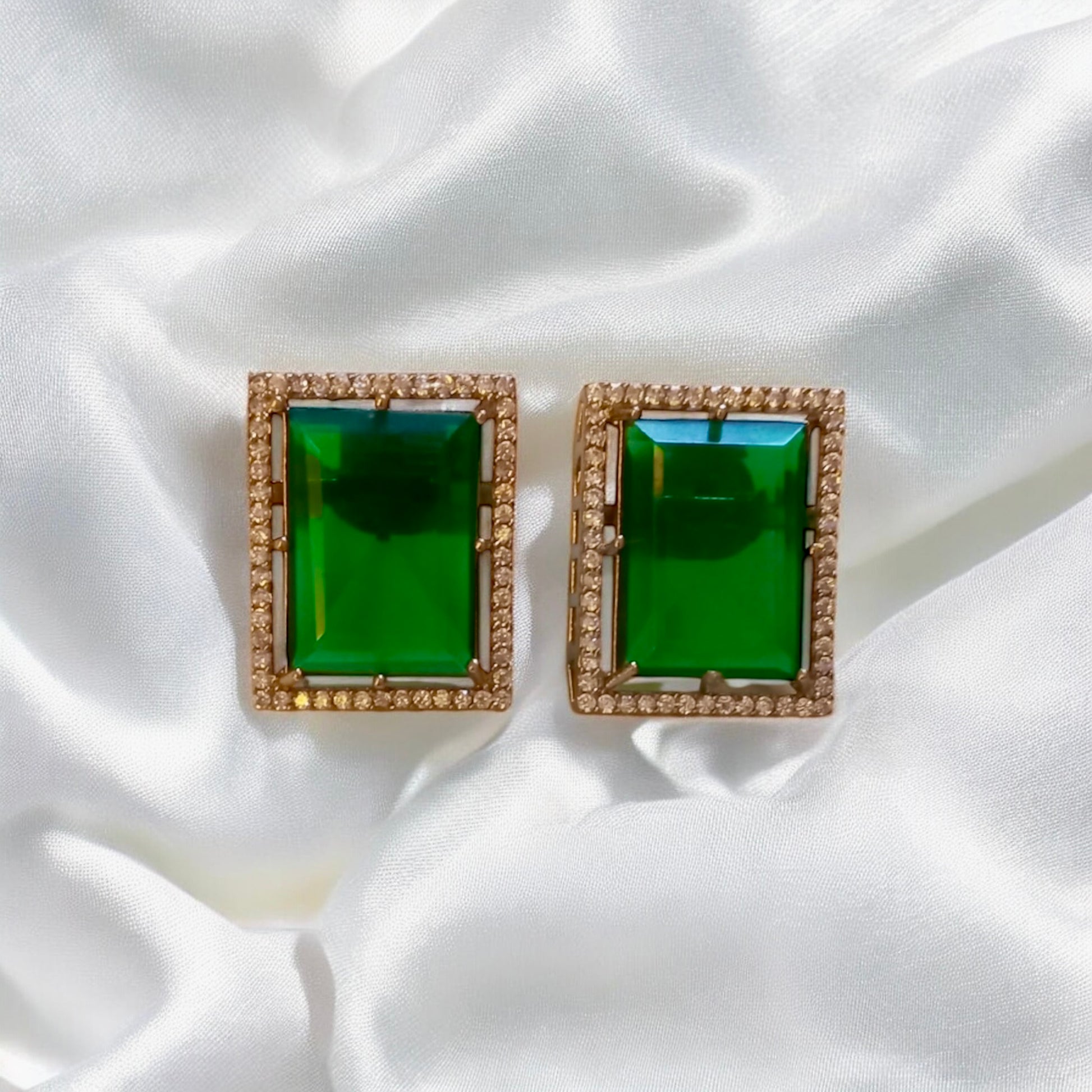 Emerald green moissanite Earrings with double layer rectangular earrings on White Fabric  background