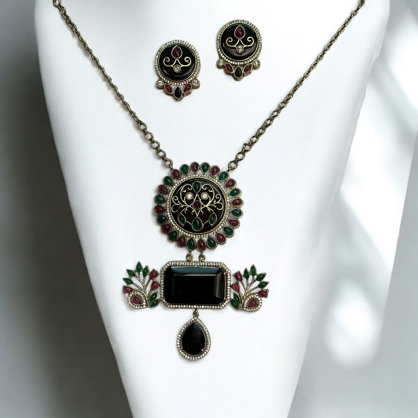 Amrapali-style long necklace with intricate black, red, and green accents, paired with matching earrings in a fusion-inspired design.