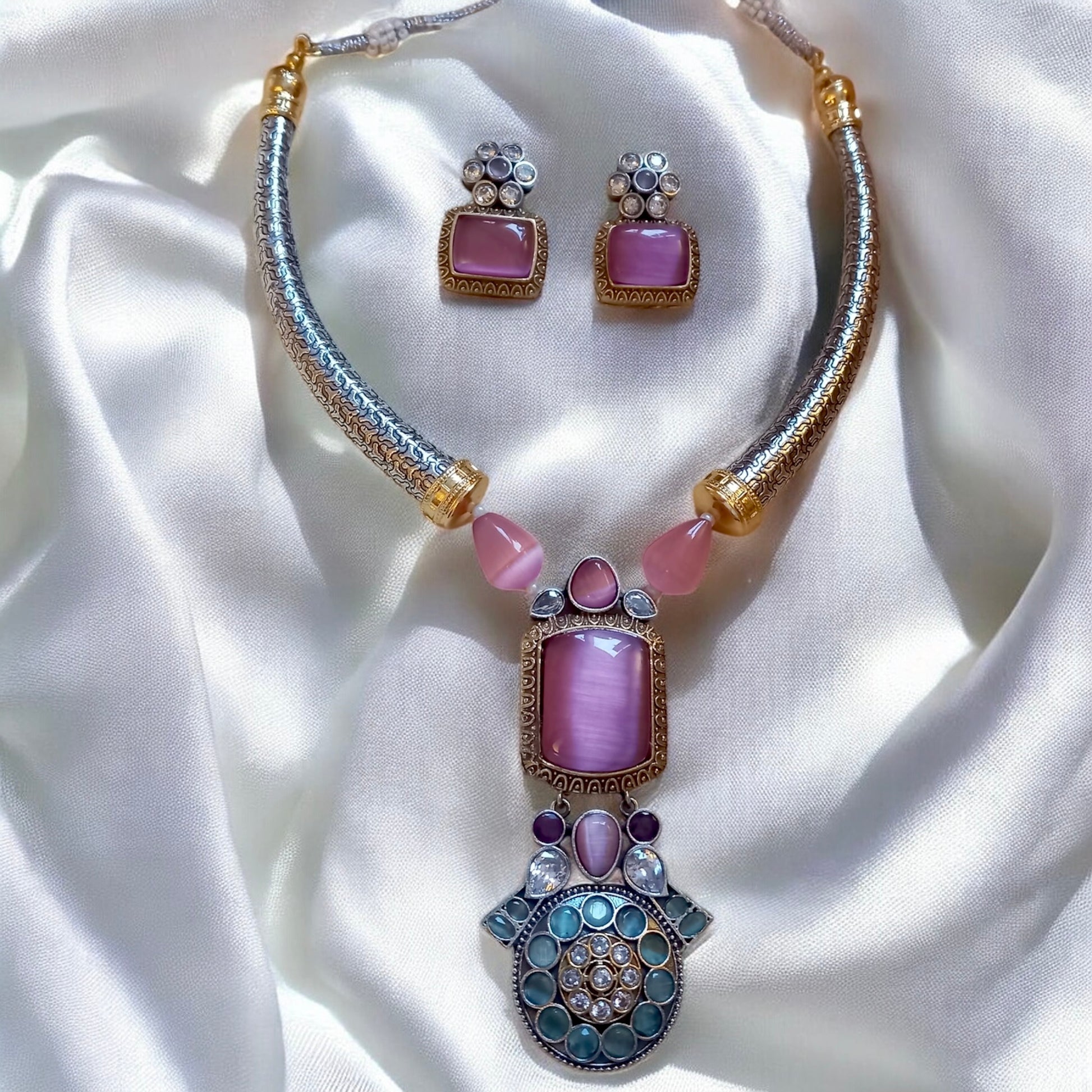 German silver hasli-style necklace with pink Monalisa stones and antique detailing, paired with matching square stud earrings on satin background