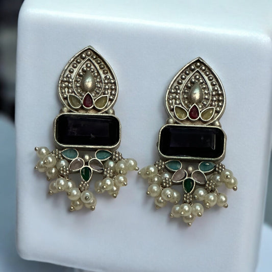 Ethnic German silver earrings with black stone centerpiece, multi-colored enamel detailing, and pearl accents.