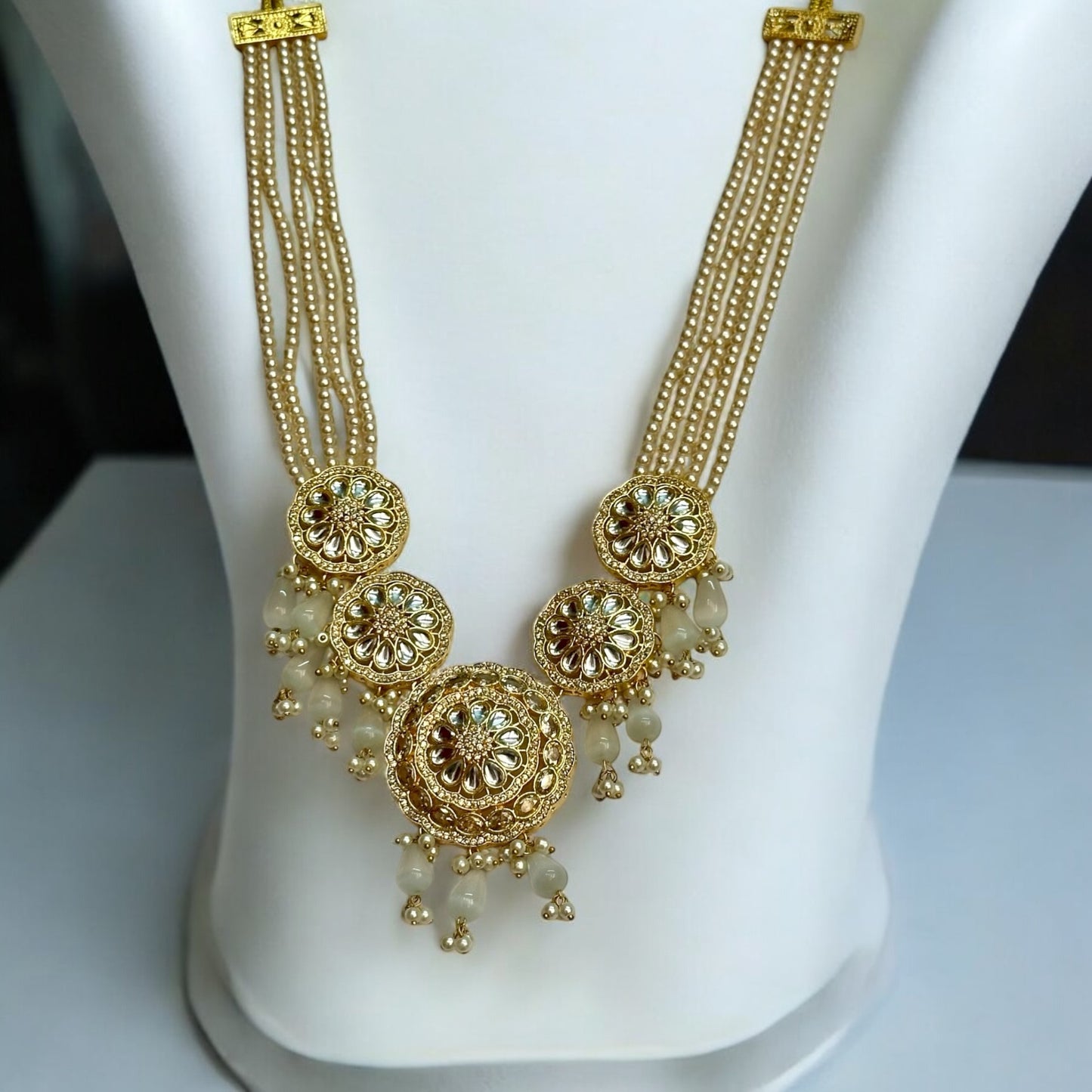 Kundan Pearl Golden Necklace - Traditional Indian Gold Plated Jewelry, Featuring Golden Beads and Pearl Drops - Displayed on White Jewelry Stand for Elegant Presentation