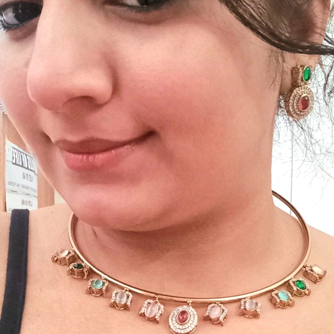 A model wearing a Moissanite Premium Hasli in Multi-Colour Necklace Set with Matching Earrings – a modern gold-tone necklace with sparkling moissanite stones and vibrant multi-colour accents. Ideal for festive and traditional occasions.