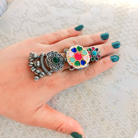 A woman's hand adorned with a Multicolor Fusion Ring, featuring an intricate long adjustable design with colorful gemstones, complementing an ethnic-inspired look.