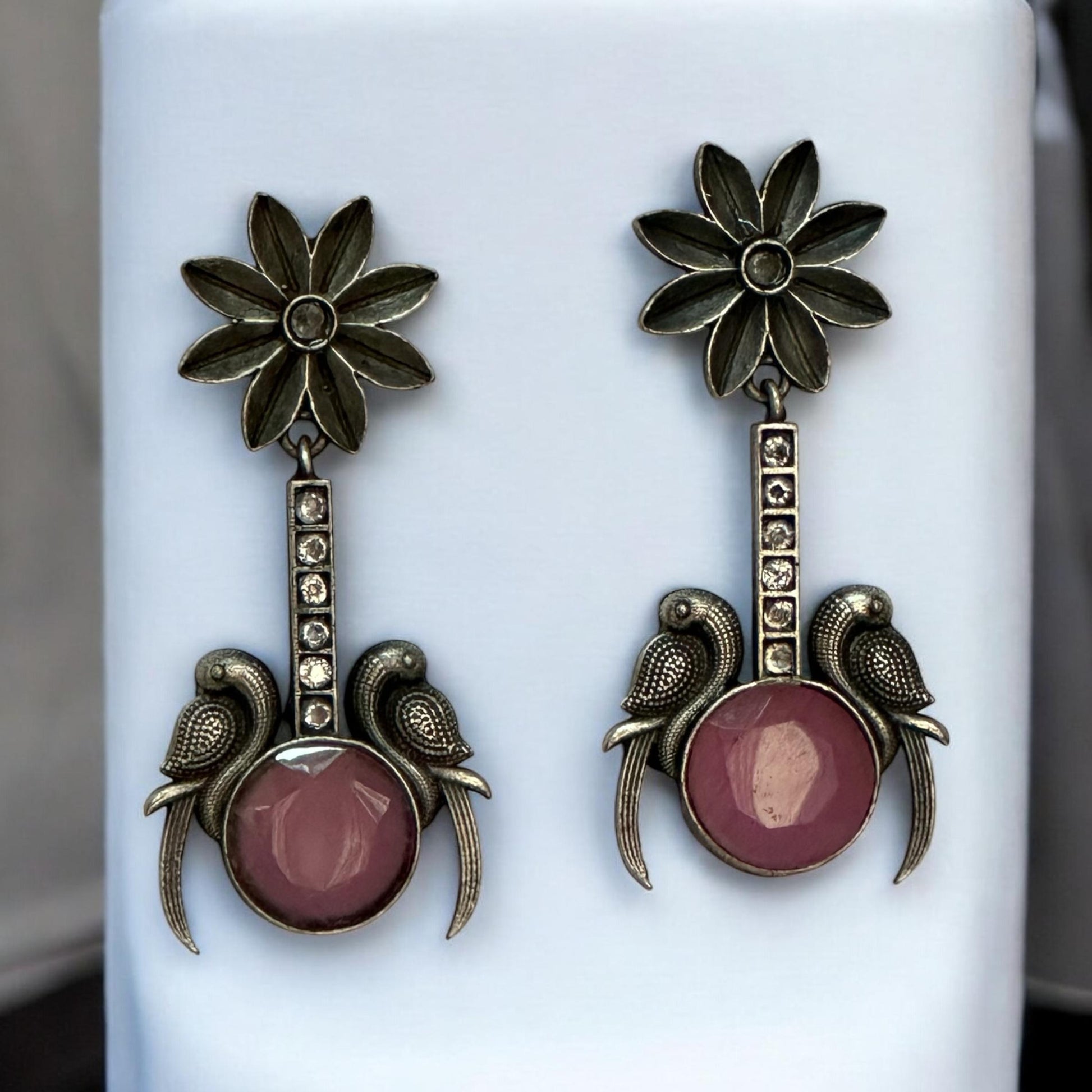 Close-up of Pink Stone Silver Replica Earrings featuring dual bird design and antique floral motif – ethnic jewellery for women in London UK