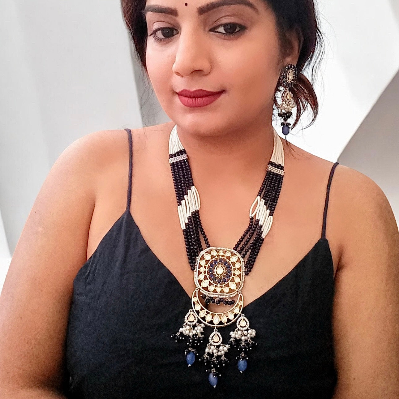 A Model displaying Polki Kundan with American Diamond Rani Har Necklace Set with earrings.