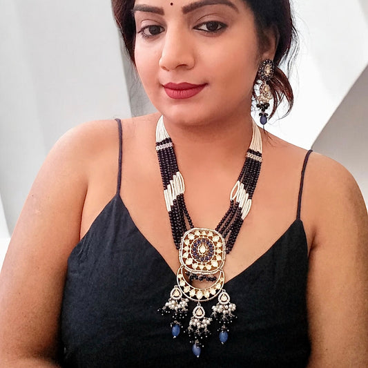 A Model displaying Polki Kundan with American Diamond Rani Har Necklace Set with earrings.