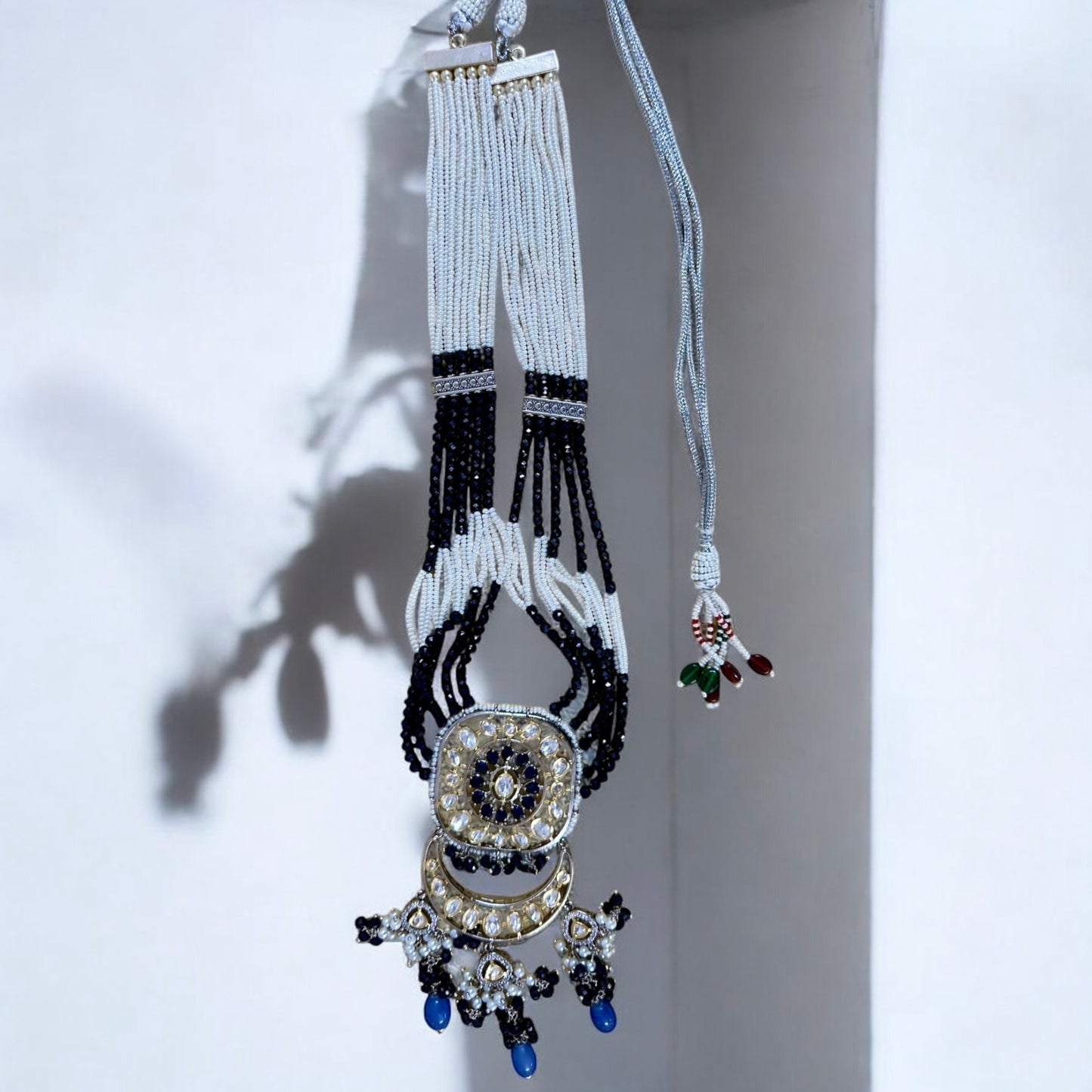 Polki Kundan with American Diamond Rani Har Necklace Set with hanging with a white wall background