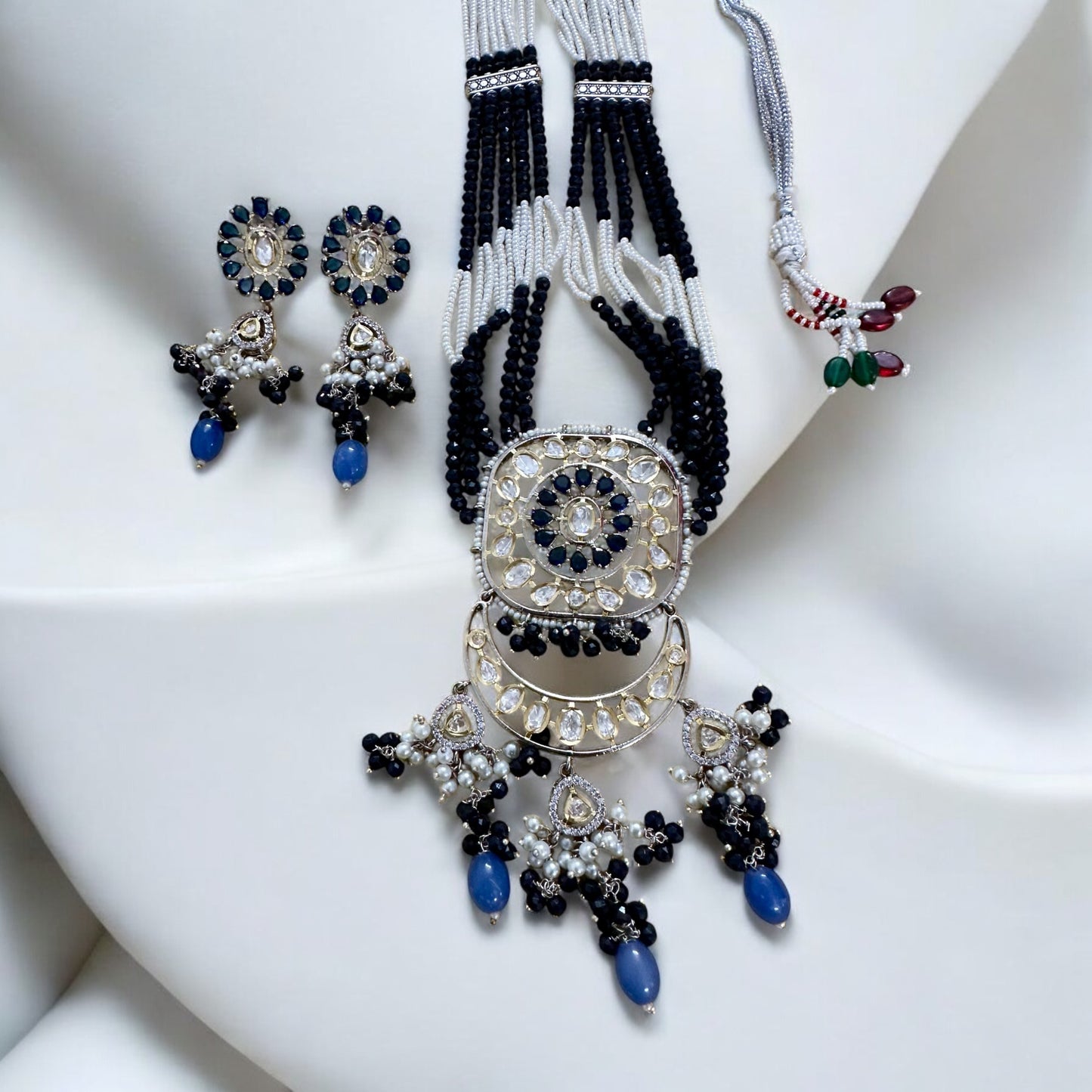 Polki Kundan with American Diamond Rani Har Necklace Set with earrings lying on a white fabric background