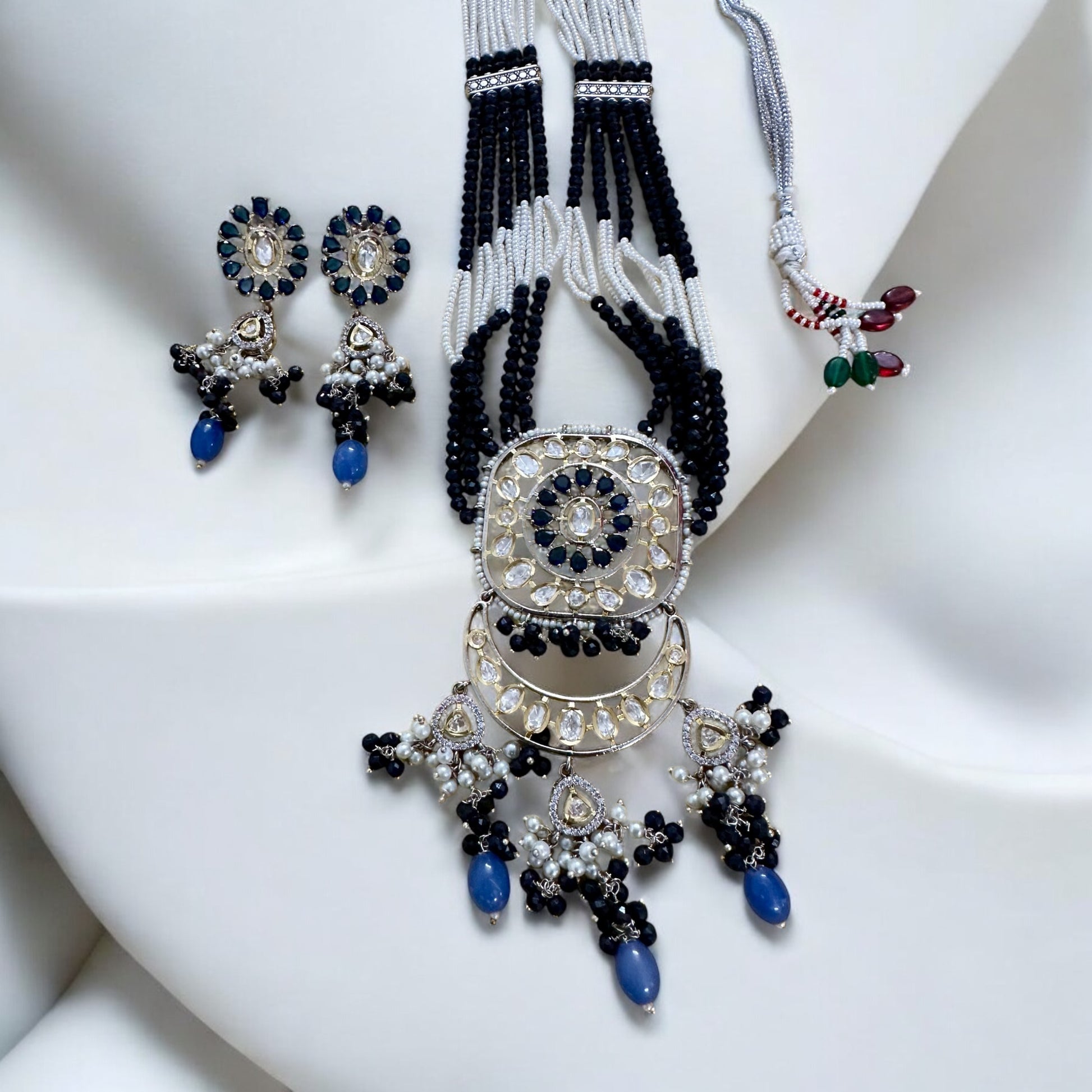 Polki Kundan with American Diamond Rani Har Necklace Set with earrings lying on a white fabric background