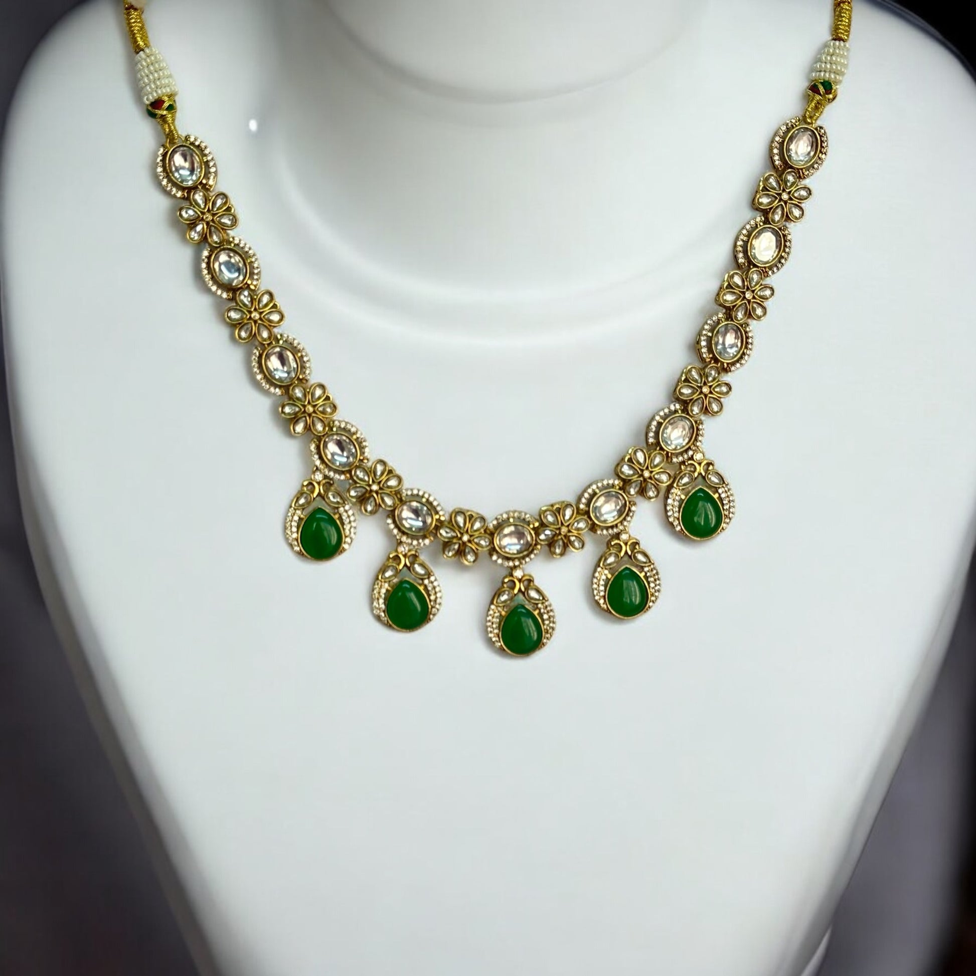 Polki Kundan Premium Necklace – featuring floral motifs, green teardrop stones, and intricate polki and kundan detailing. Perfect for festive and cultural occasions.