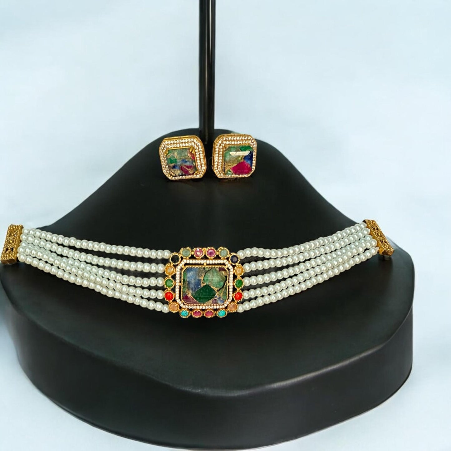 Premium Doublet Multi Colour Stone Choker Necklace Set with White Pearl Beads and matching earrings – elegant Indian designer jewellery for women in UK on a black jewellery display stand.