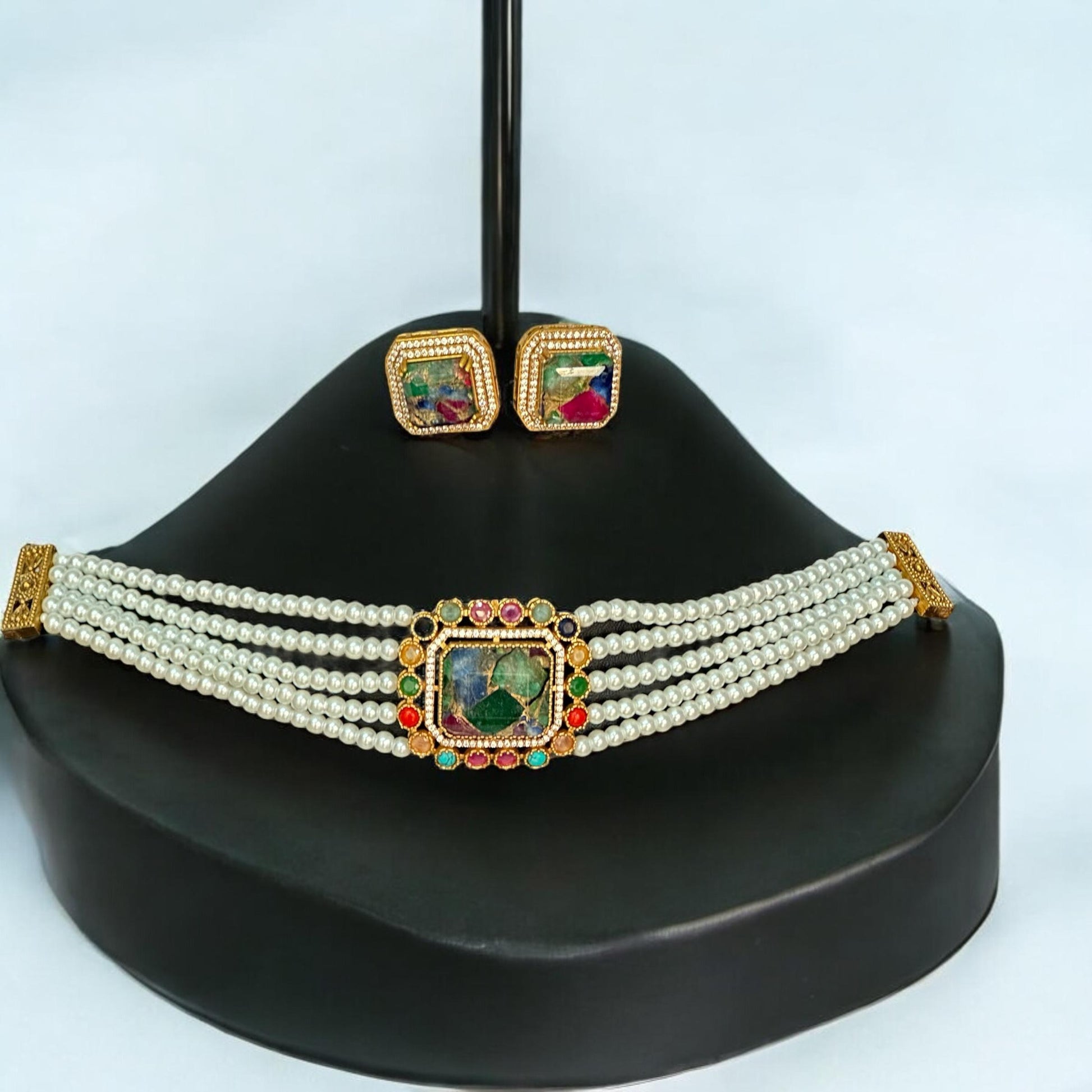 Premium Doublet Multi Colour Stone Choker Necklace Set with White Pearl Beads and matching earrings – elegant Indian designer jewellery for women in UK on a black jewellery display stand.