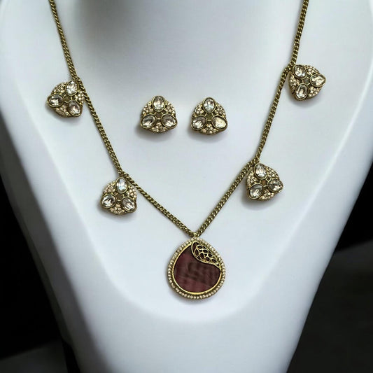 Premium moissanite pendant charms necklace set in royal purple with matching moissanite earrings, displayed on a white stand