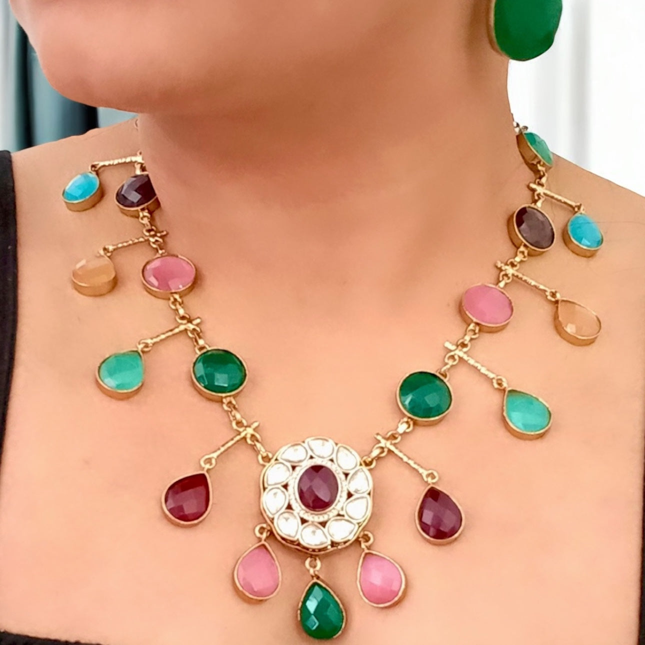 A model displaying a Premium Polki Kundan With Semi-Precious Stone Multi Colour Necklace Set With Earrings.