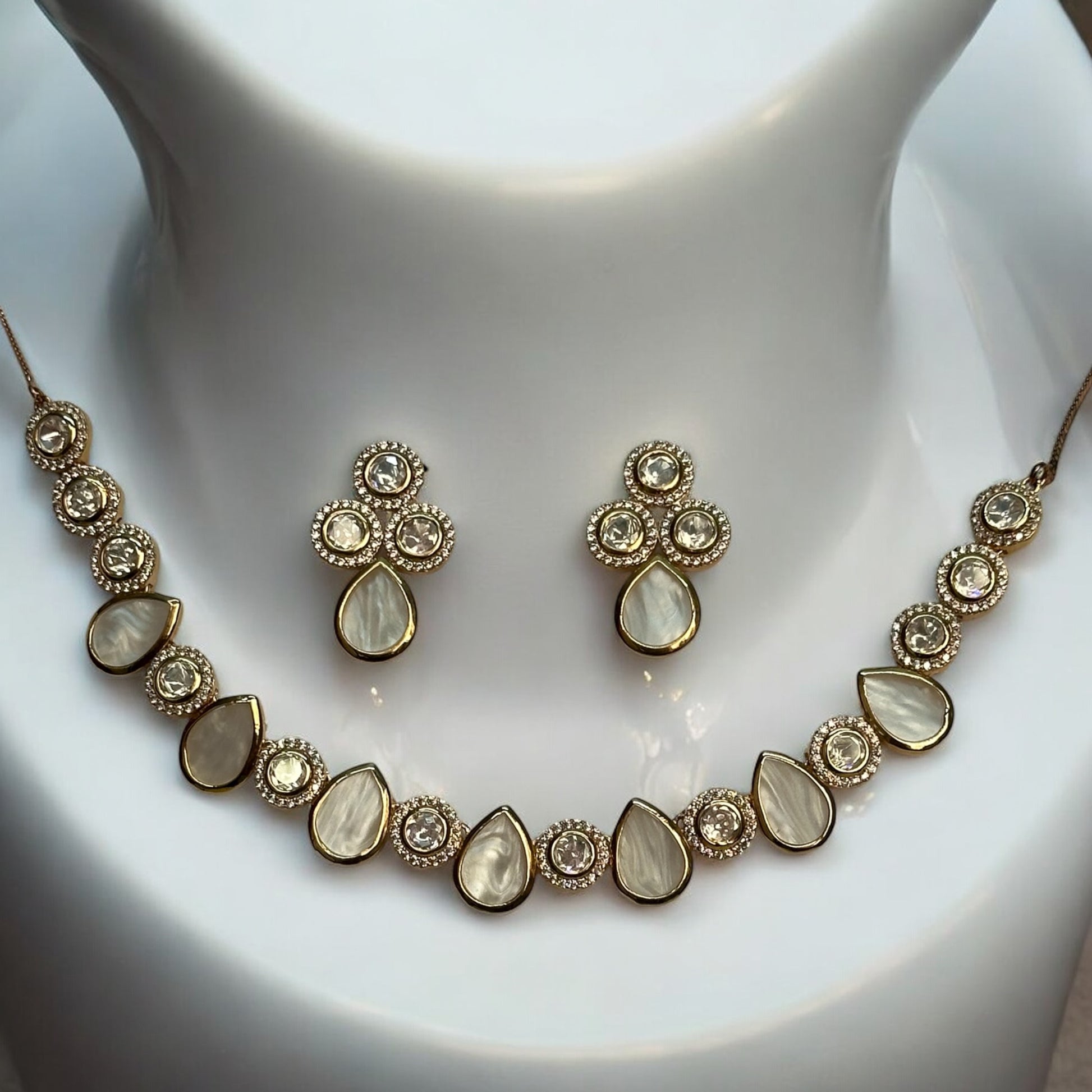 Premium Real Mother of Pearl with Polki Kundan Necklace and Earrings – elegant gold-tone necklace featuring real mother-of-pearl teardrop and polki kundan accents with matching earrings Placed on a white jewellery display stand. Perfect for weddings and festive wear.