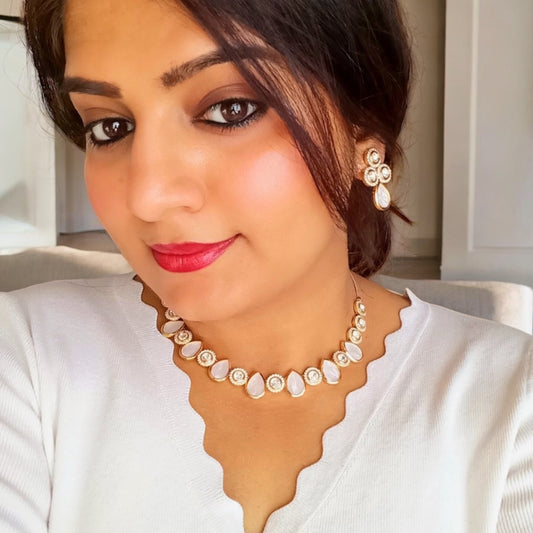 A model wearing and displaying closeup of a Premium Real Mother of Pearl with Polki Kundan Necklace and Earrings – elegant gold-tone necklace featuring real mother-of-pearl teardrop and polki kundan accents with matching earrings. Perfect for weddings and festive wear.