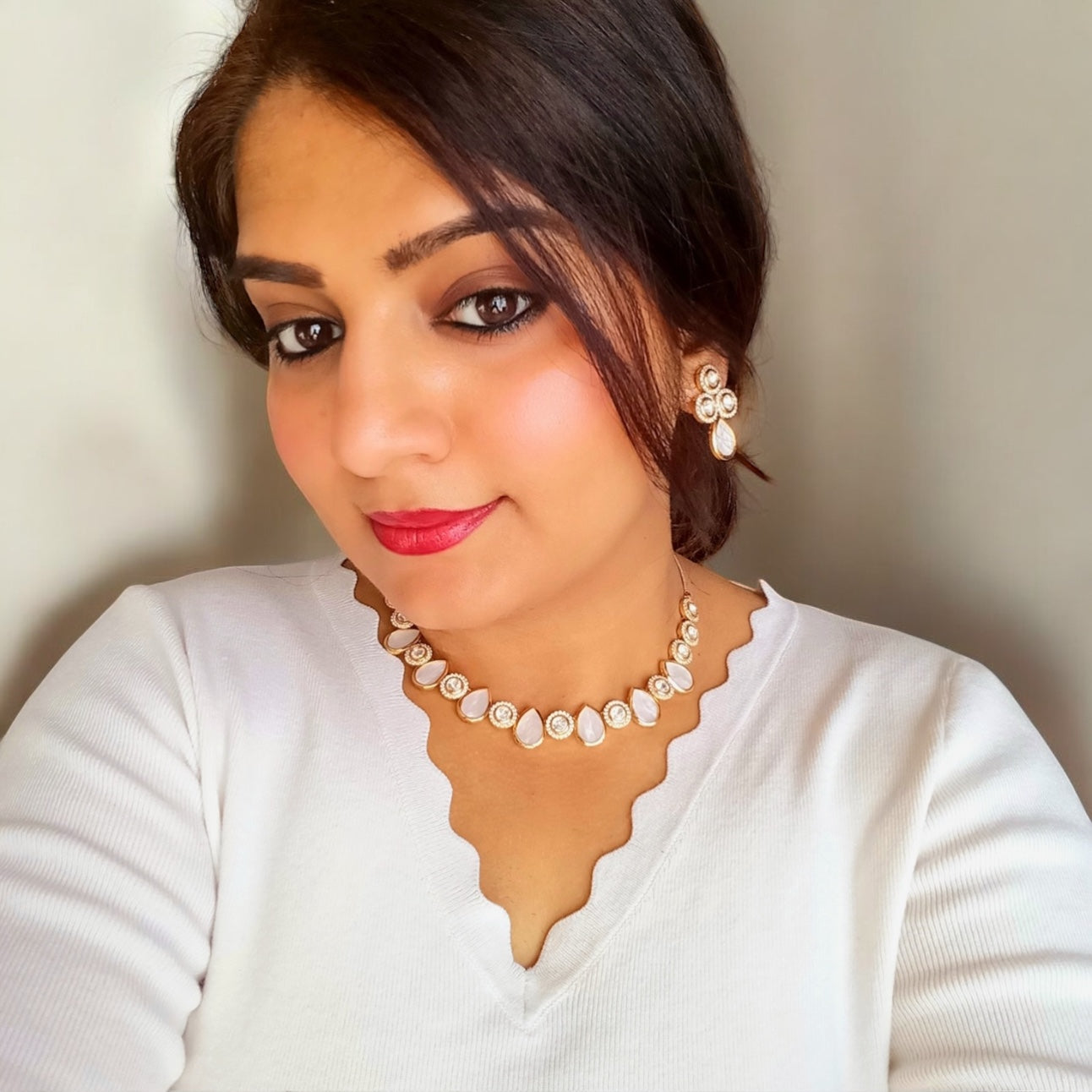 A model wearing and displaying Premium Real Mother of Pearl with Polki Kundan Necklace and Earrings – elegant gold-tone necklace featuring real mother-of-pearl teardrop and polki kundan accents with matching earrings. Perfect for weddings and festive wear.
