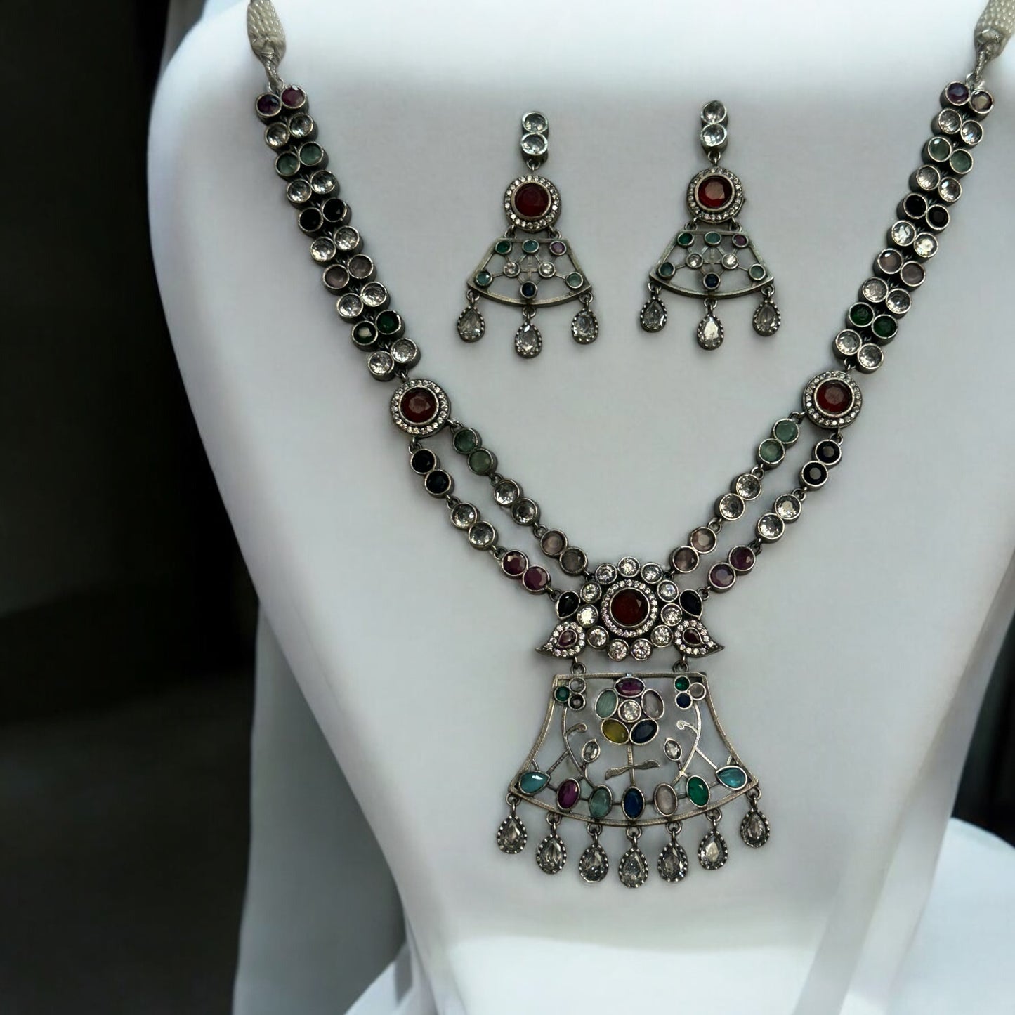 Premium Silver Look-Alike Multicolor Statement Necklace with Earrings – intricately designed silver-tone necklace with vibrant multicolor stones and matching earrings. Perfect for festive and cultural occasions.