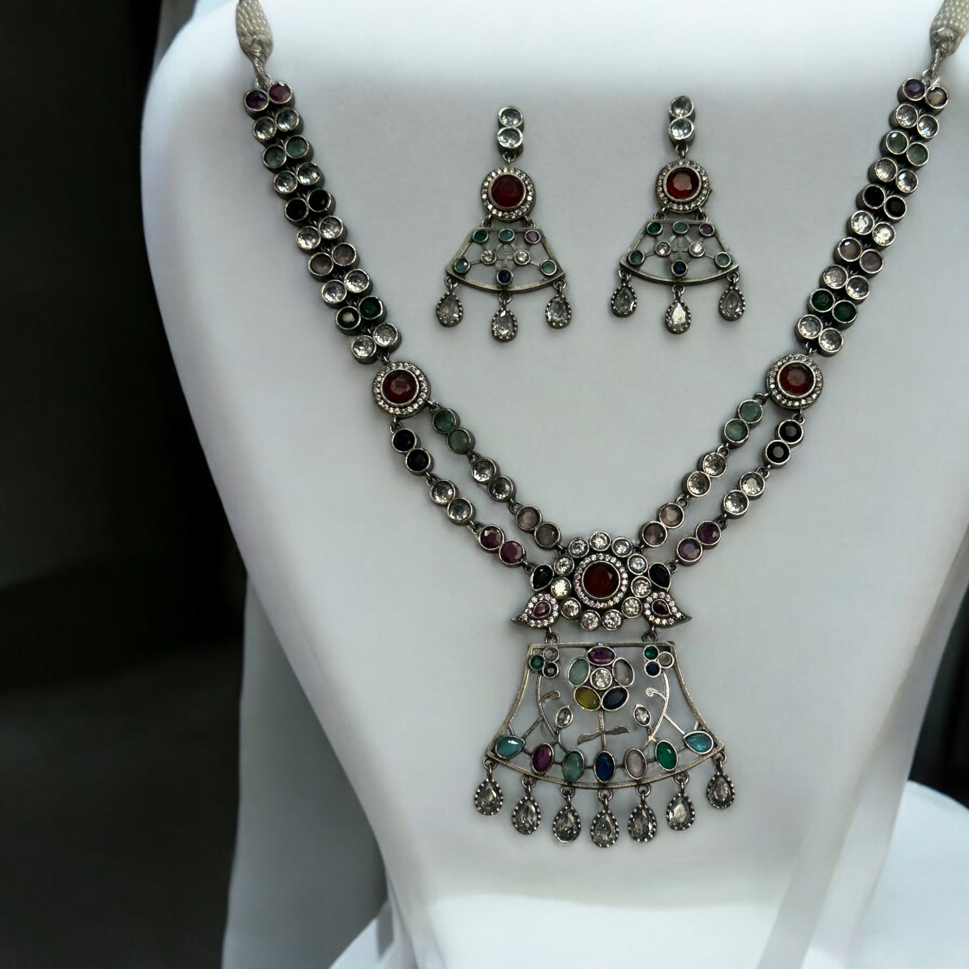 Premium Silver Look-Alike Multicolor Statement Necklace with Earrings – intricately designed silver-tone necklace with vibrant multicolor stones and matching earrings. Perfect for festive and cultural occasions.
