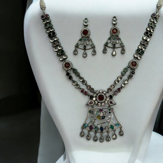 Premium Silver Look-Alike Multicolor Statement Necklace with Earrings – intricately designed silver-tone necklace with vibrant multicolor stones and matching earrings. Perfect for festive and cultural occasions.