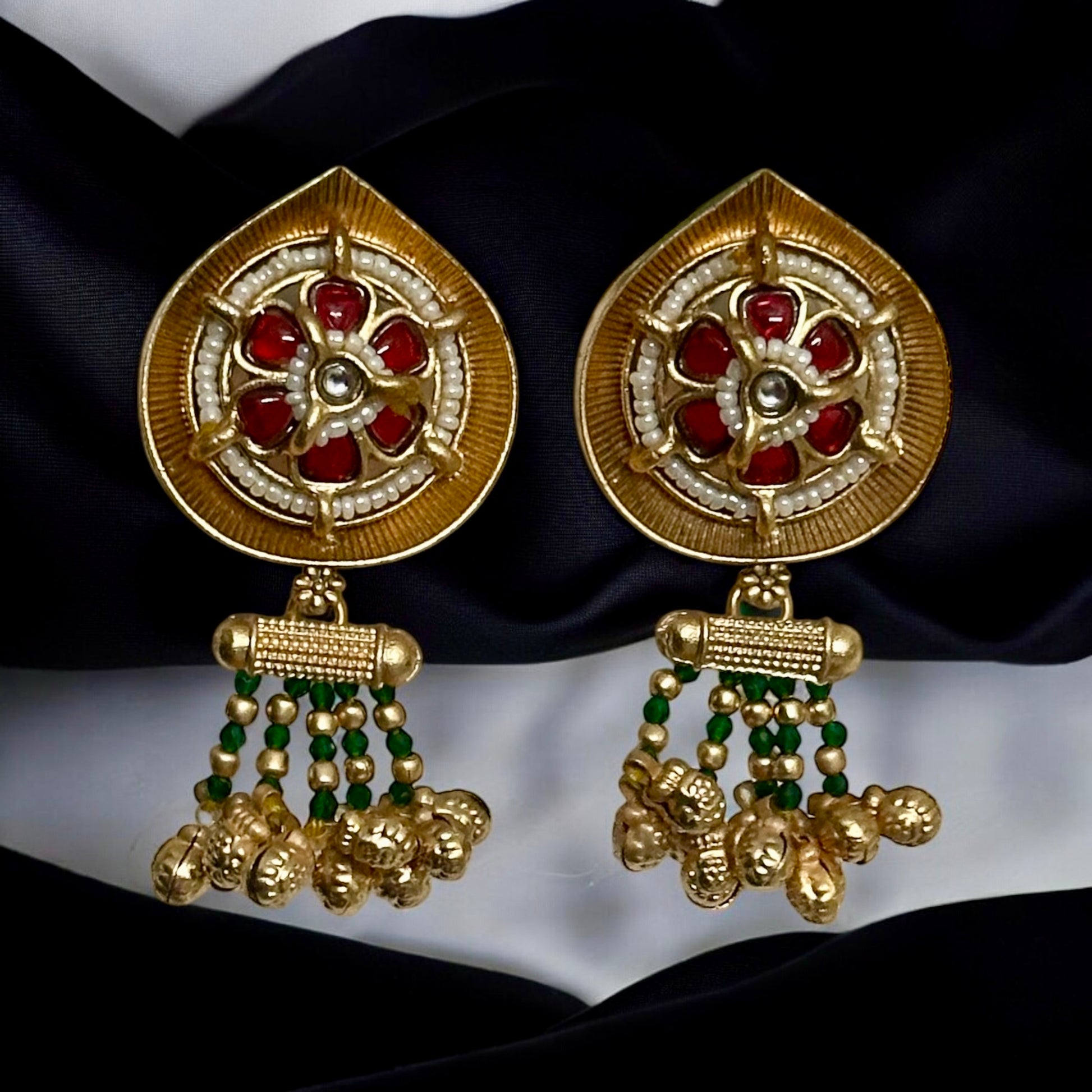 Rajwadi Kundan earrings hanging on a black colored fabric.
