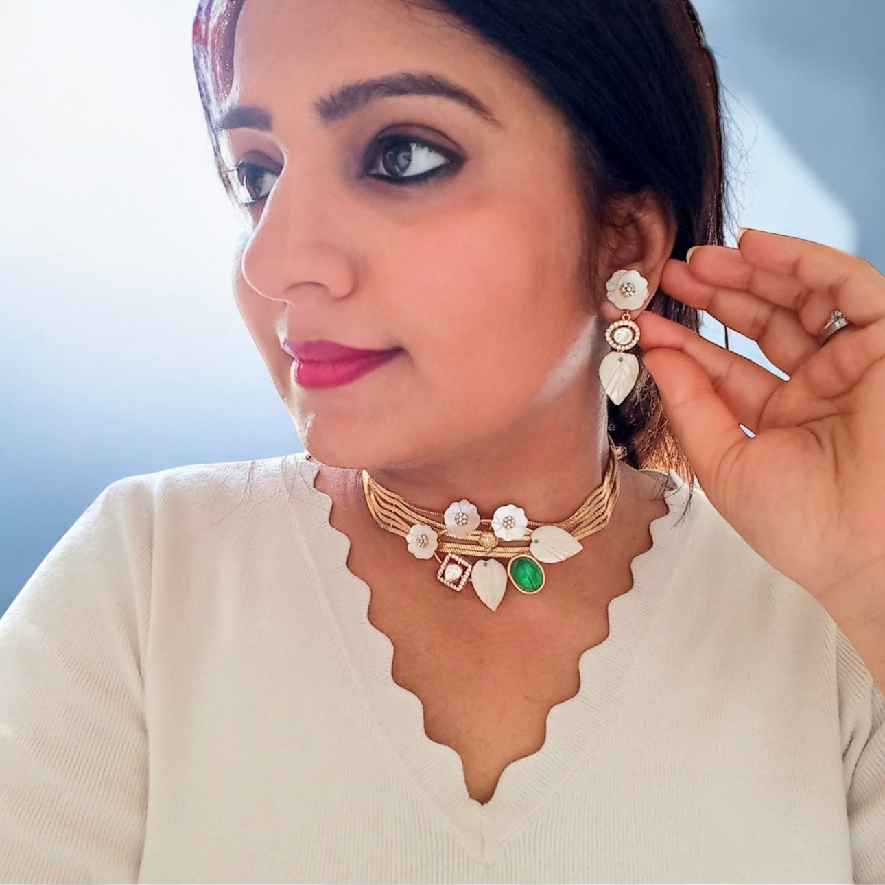 A model displaying in side look a  Real MOP Moissanite Gold Plated Kundan Choker Necklace set.