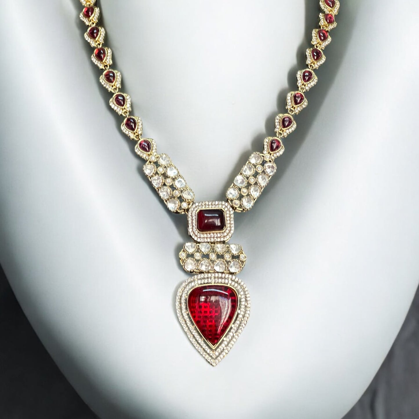 Real Moissanite Kundan Long Necklace with red gemstones, featuring a pear-shaped pendant and intricate detailing.